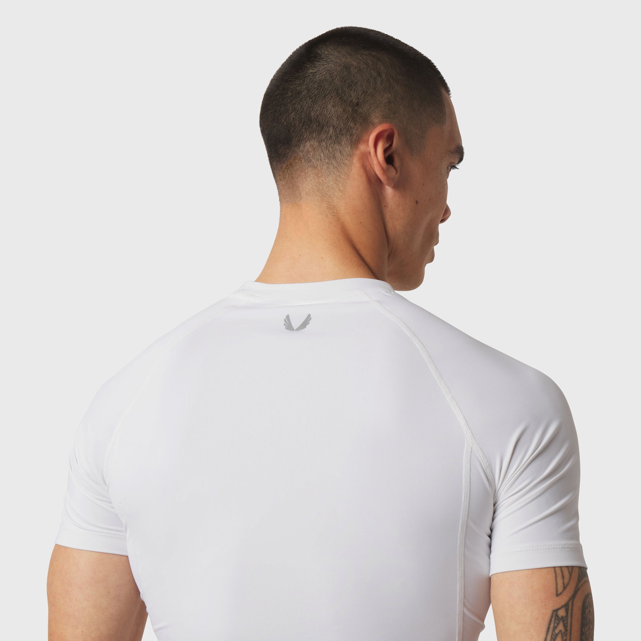 White LYCRA® ADAPTIV baselayer short sleeve tee on model, back view