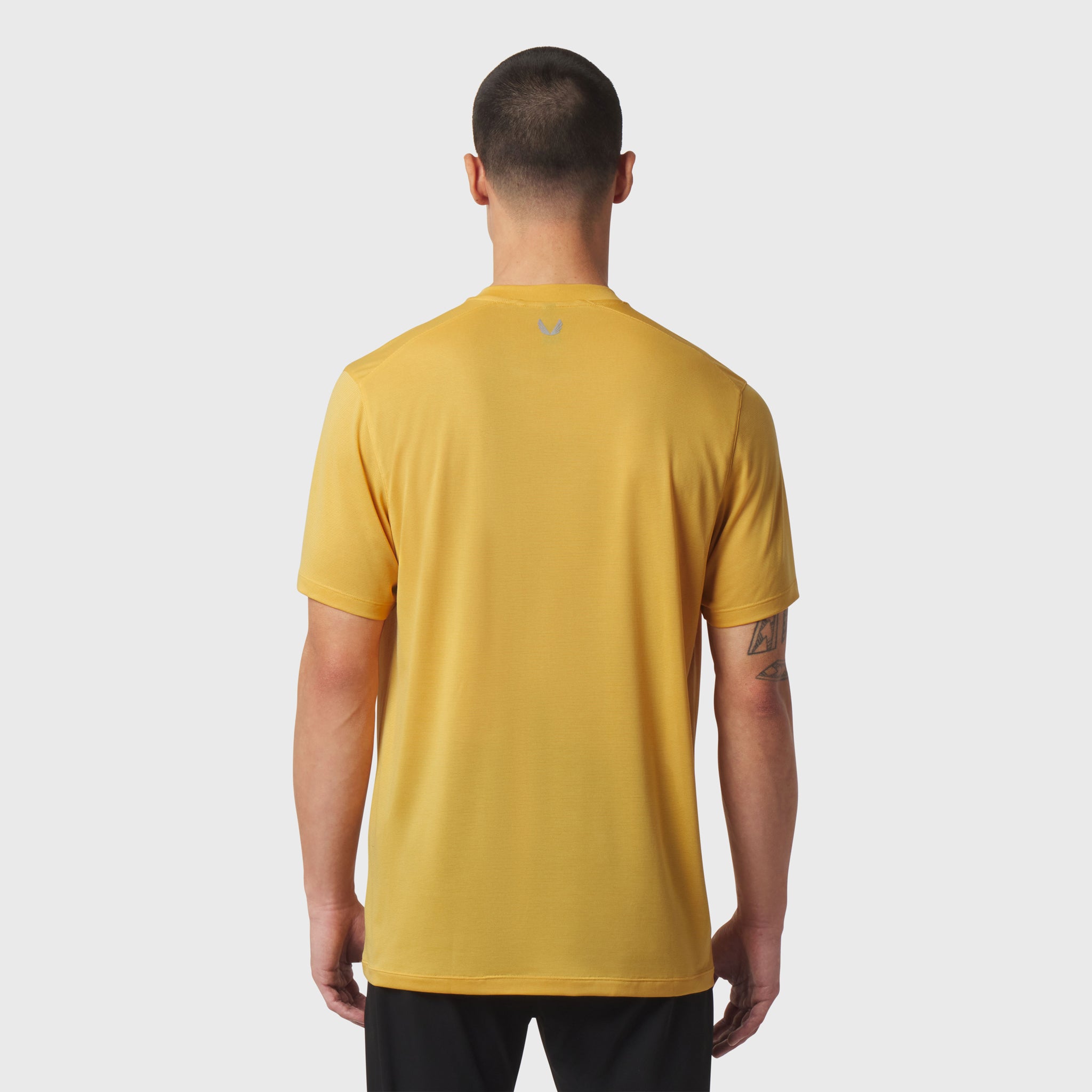 Polartec® Delta Polo in amber, back view on model