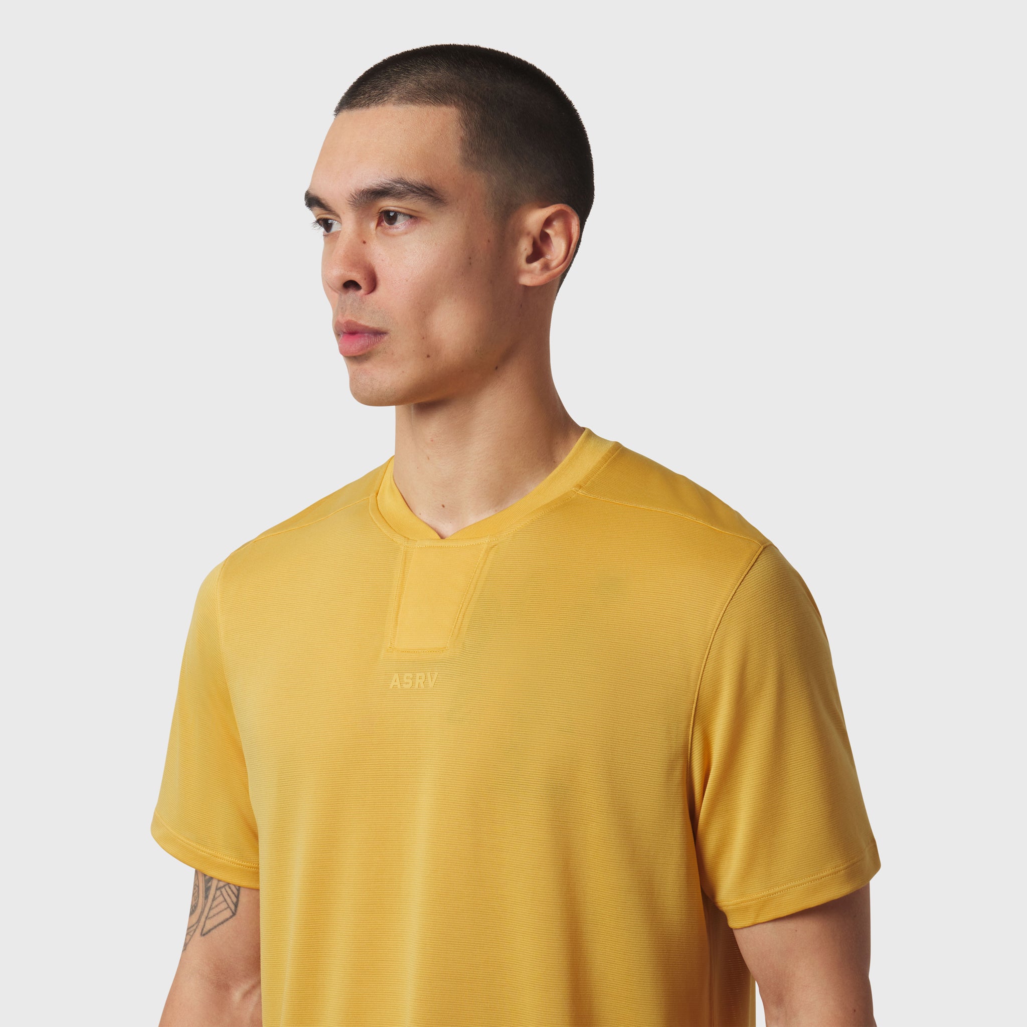 Polartec® Delta Polo in amber yellow worn by male model, front side view