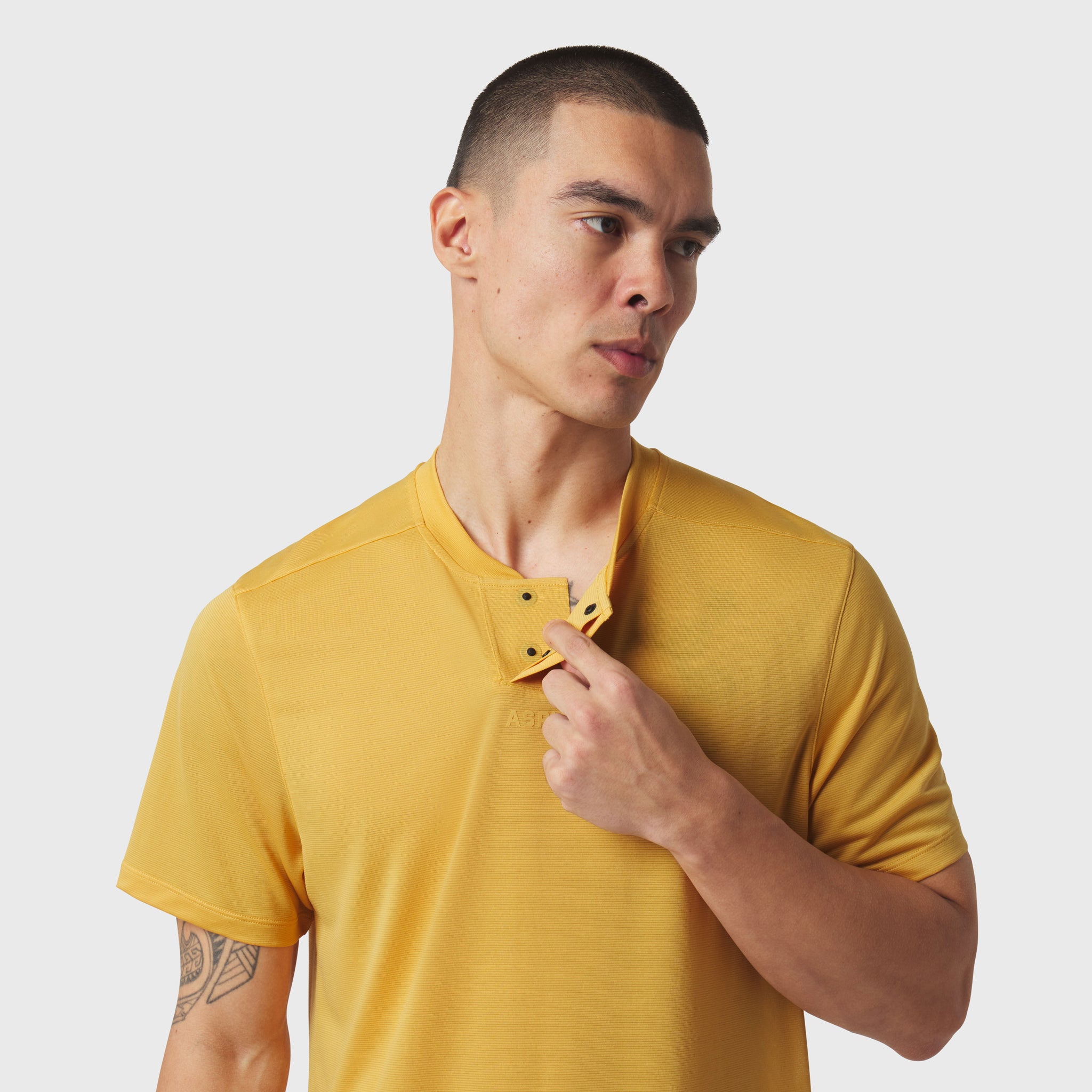 Polartec® Delta Polo in Amber yellow worn by male model, front view