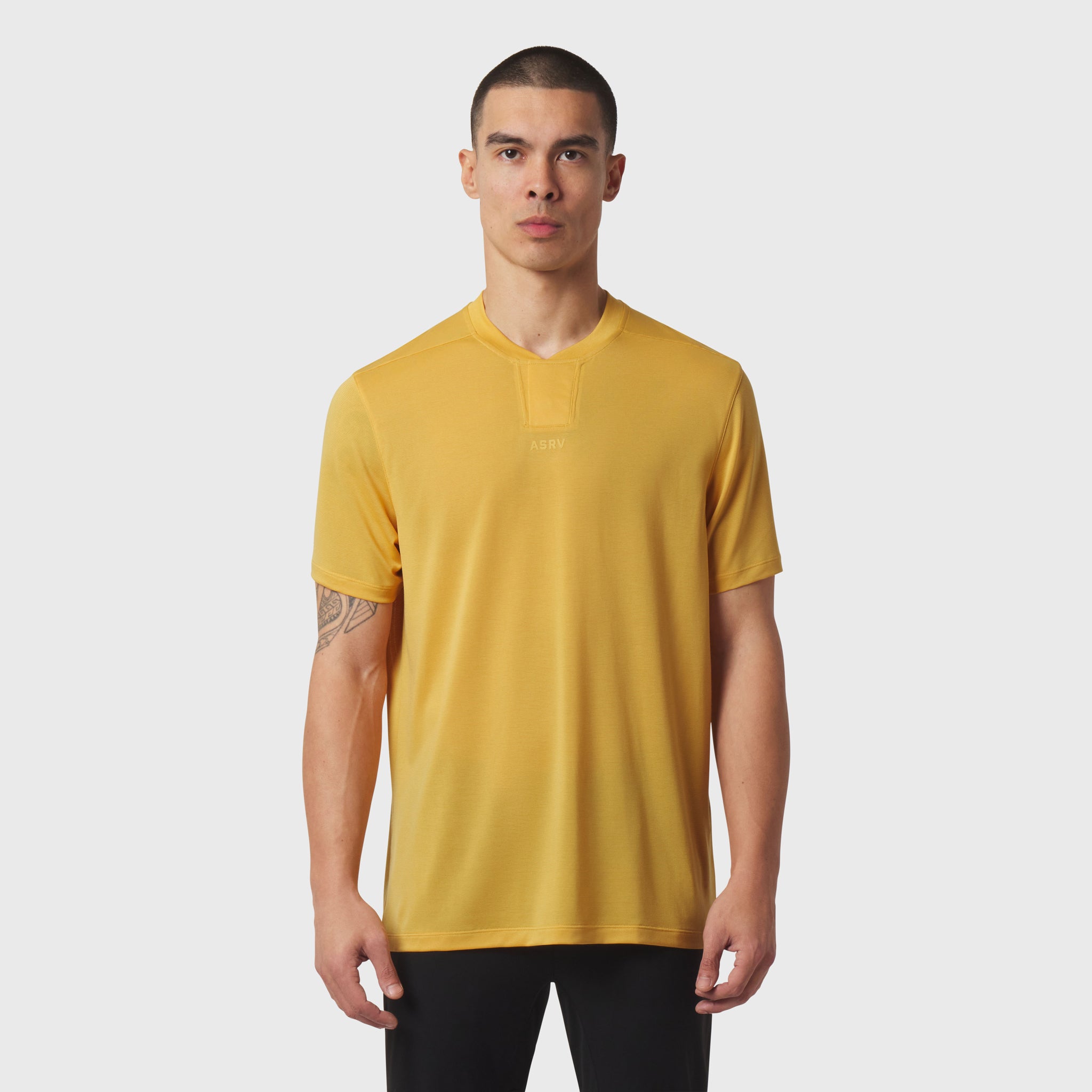 Polartec Delta Polo in amber yellow worn by male model, front view