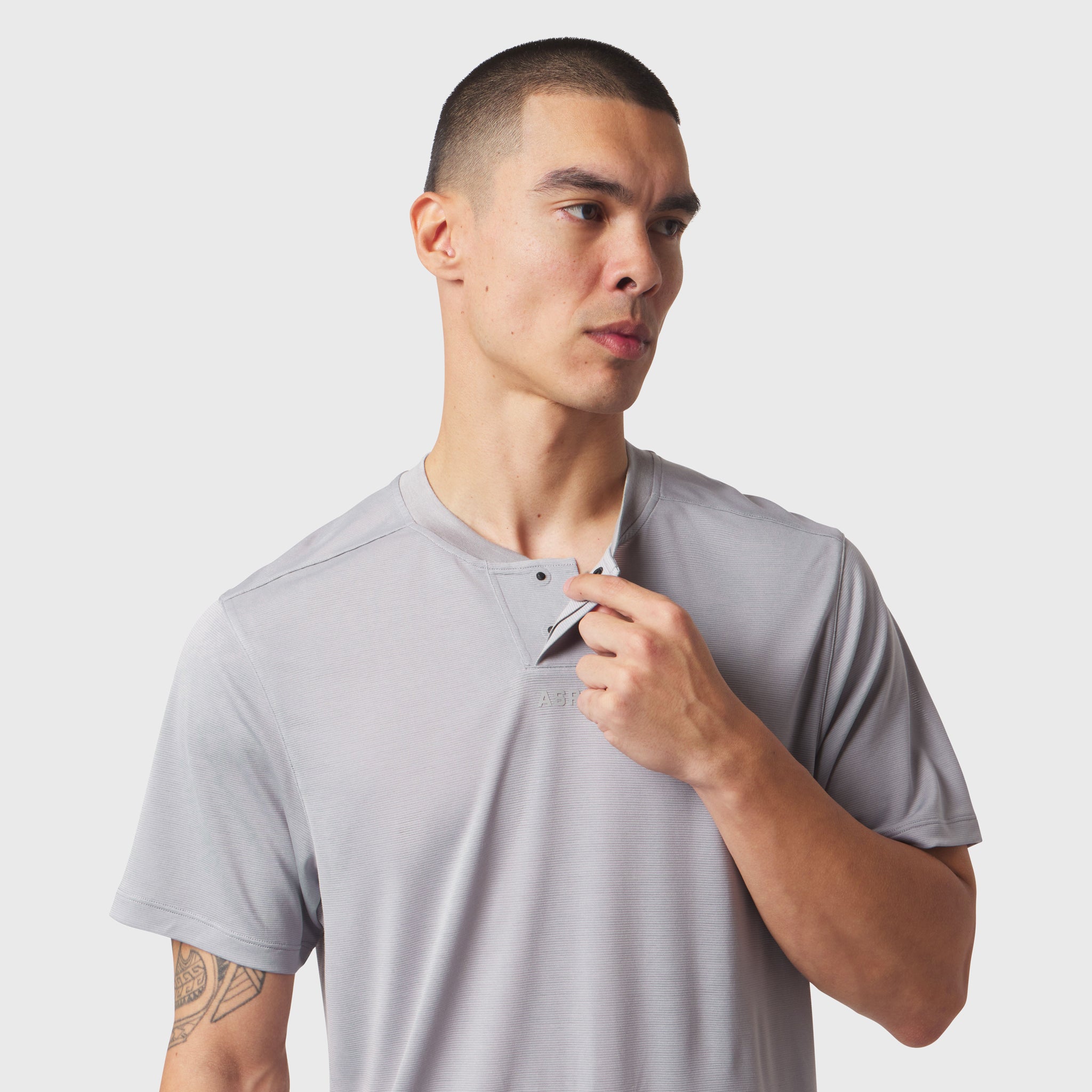 Polartec® Delta Polo in slate grey worn by model, front view with hand near chest