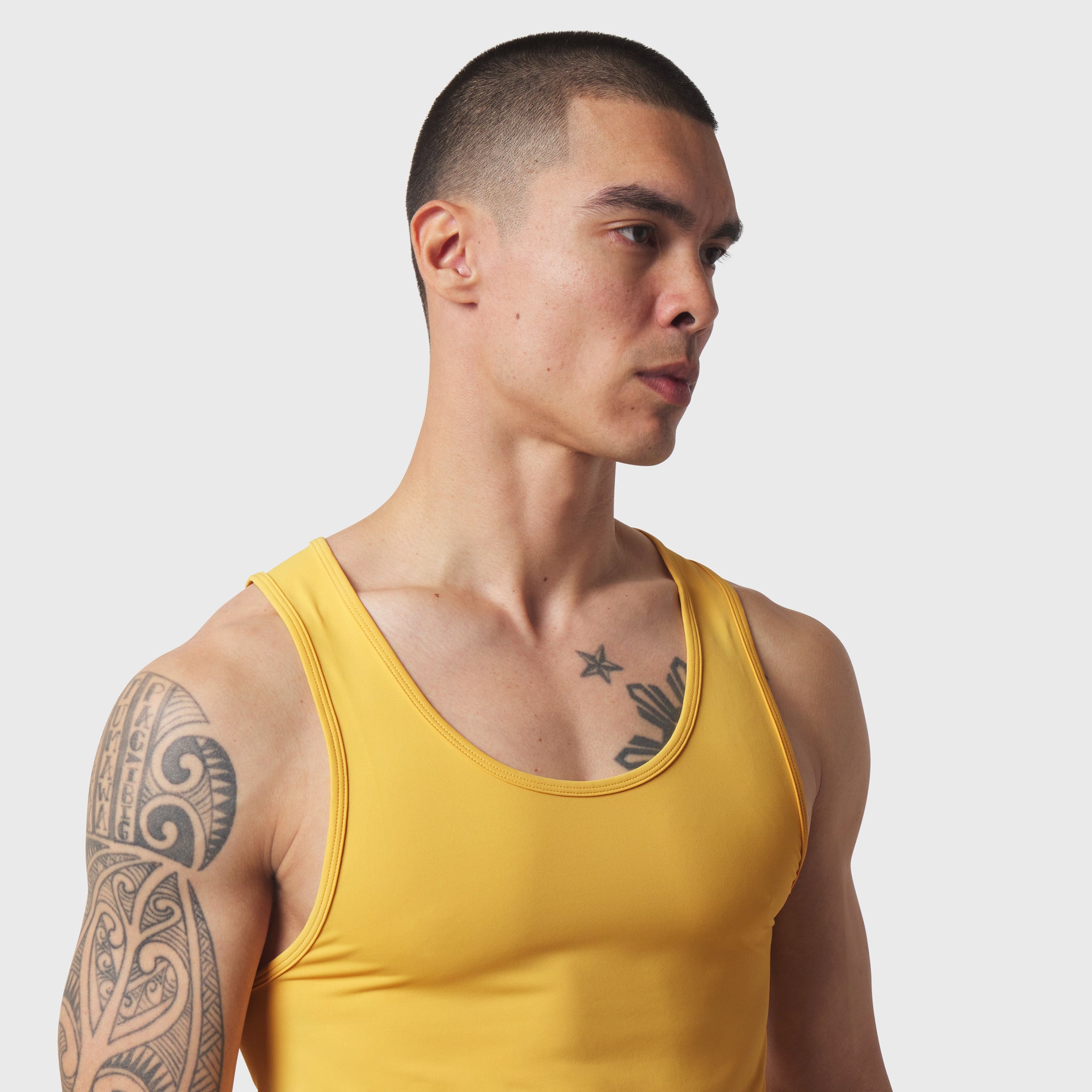 LYCRA® ADAPTIV Baselayer Tank in amber yellow, worn by model, side profile view