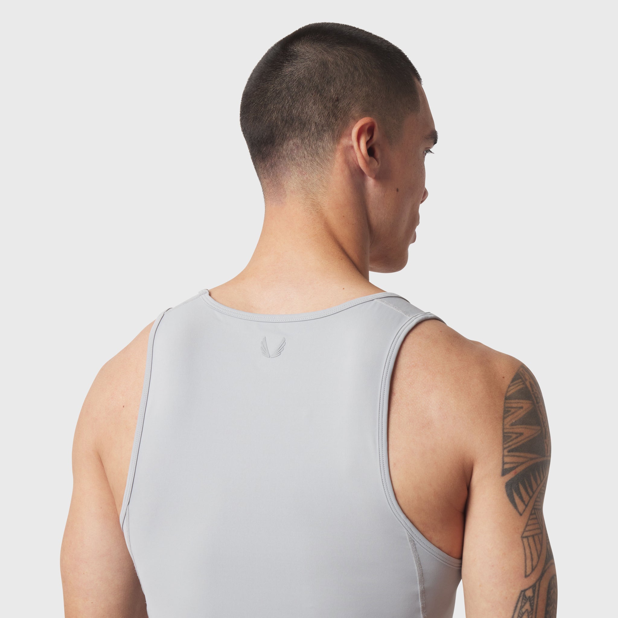 LYCRA® ADAPTIV Baselayer Tank in slate grey, worn by model shown from behind