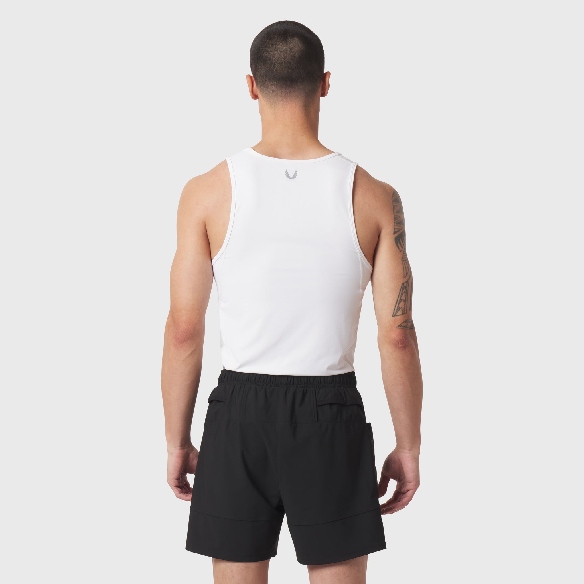 White LYCRA® ADAPTIV baselayer tank worn by model, back view