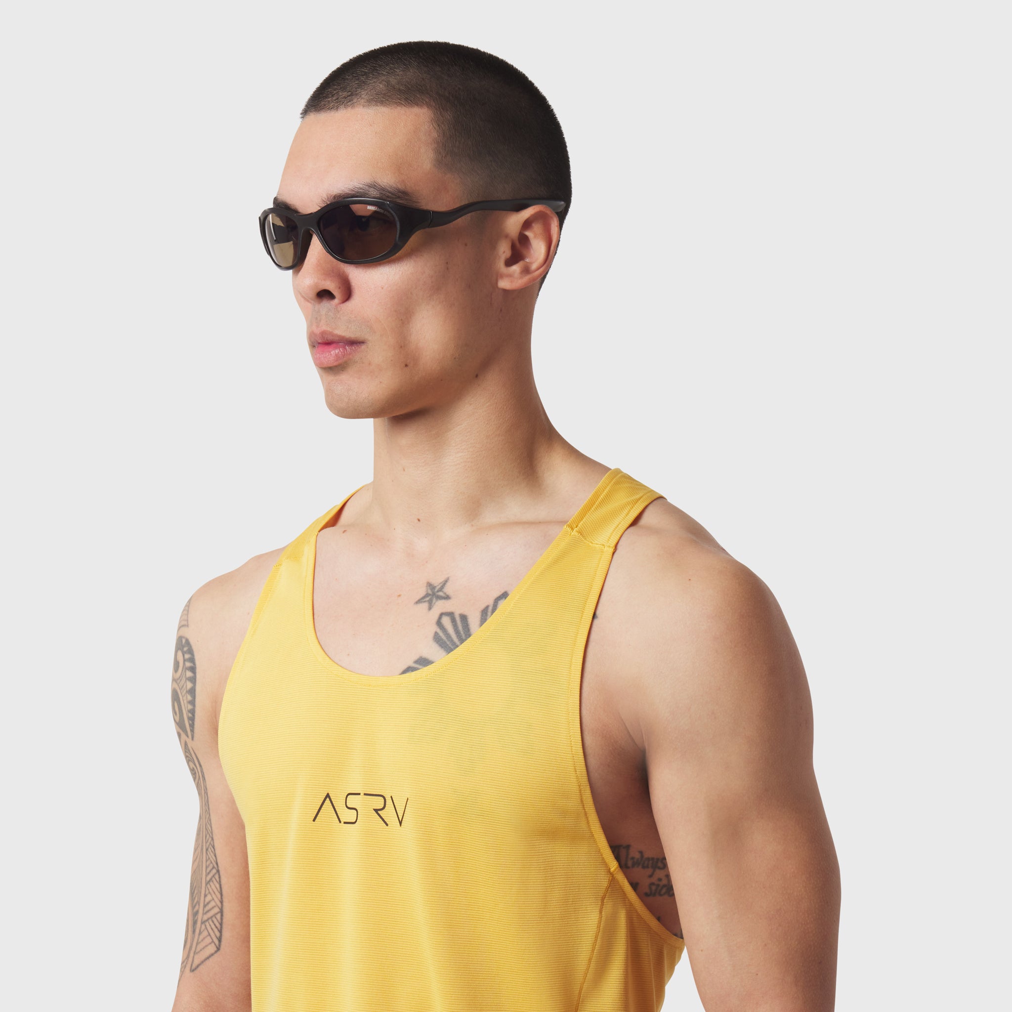 Polartec® Delta Singlet in amber yellow worn by model, side profile view