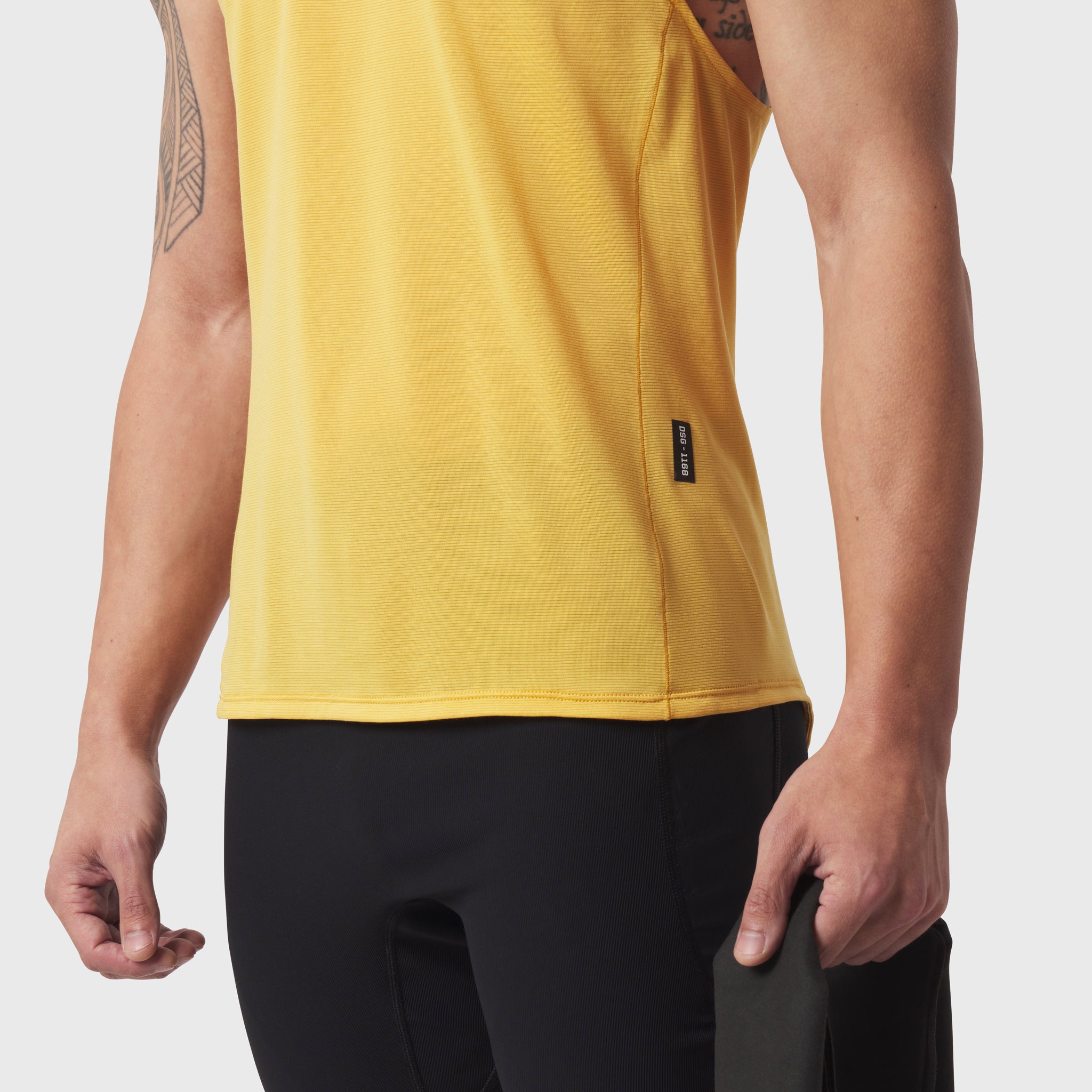 Polartec® Delta Singlet in amber yellow worn by model, side view