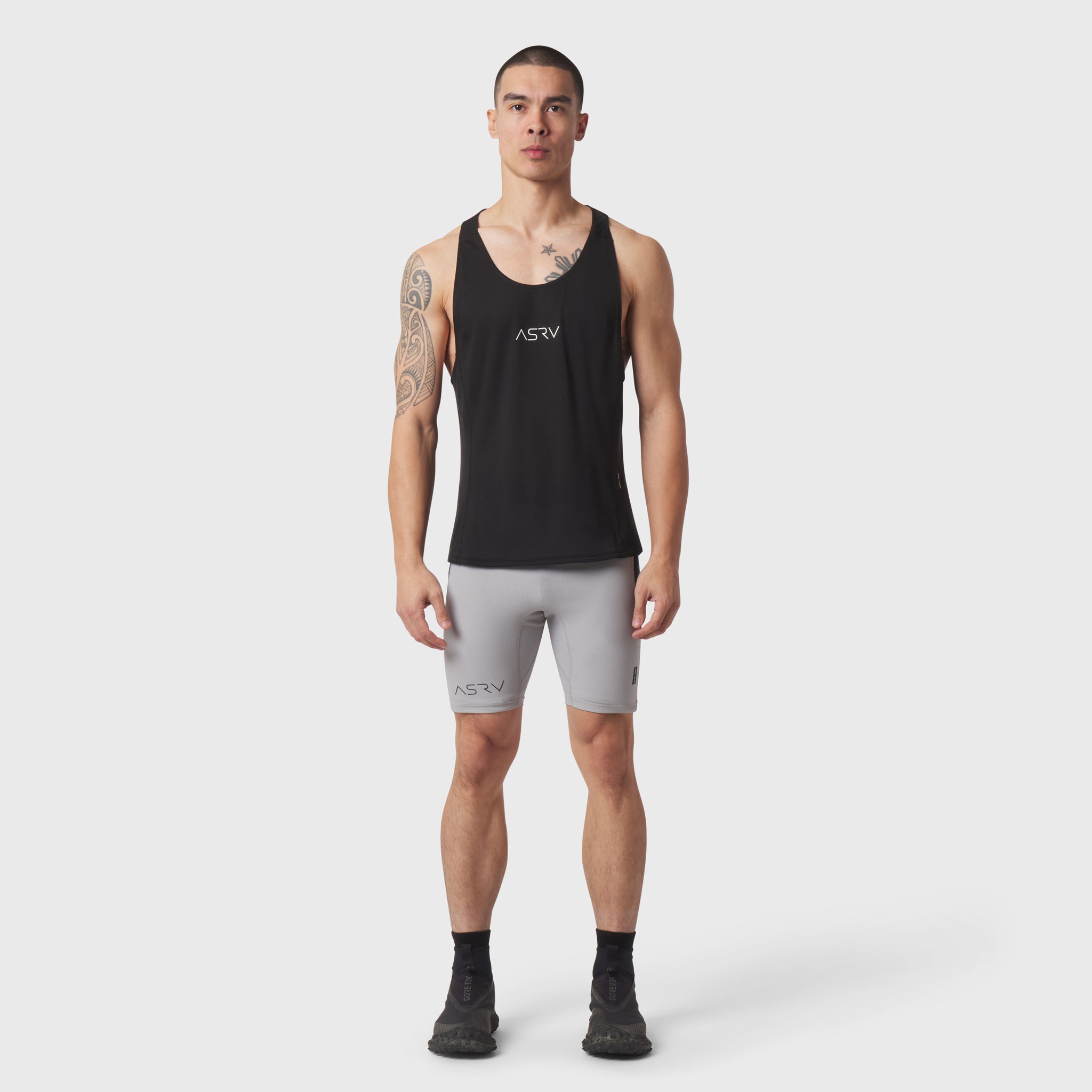 Black Polartec® Delta Singlet worn by model with grey shorts, front view
