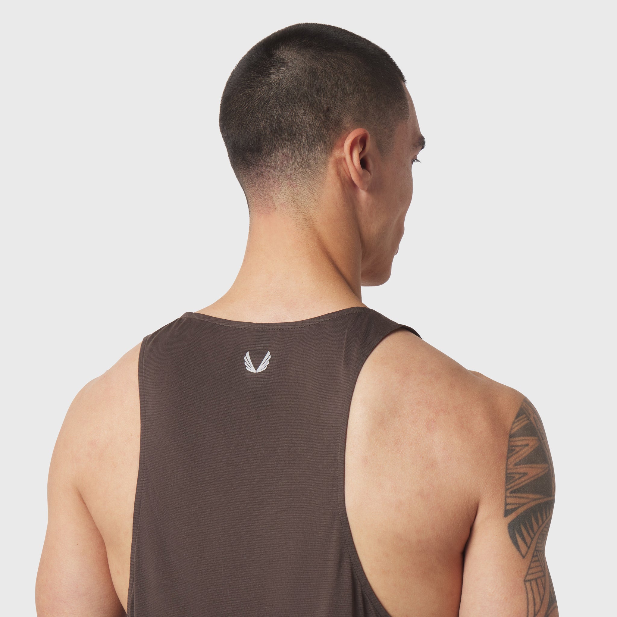 Polartec® Delta Singlet in dark earth, worn by model shown from back