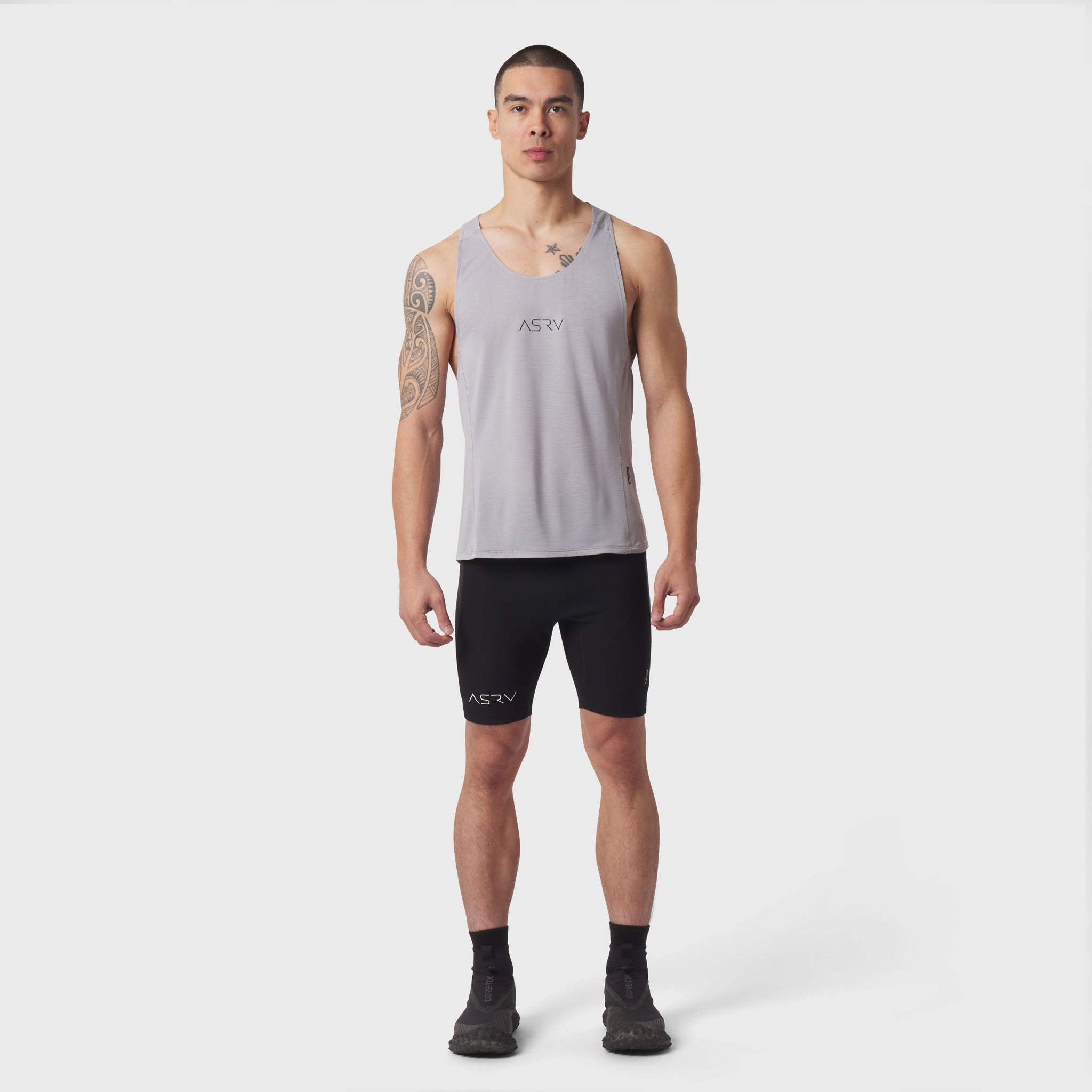 Polartec® Delta Singlet in slate grey worn by male model with black shorts, front view