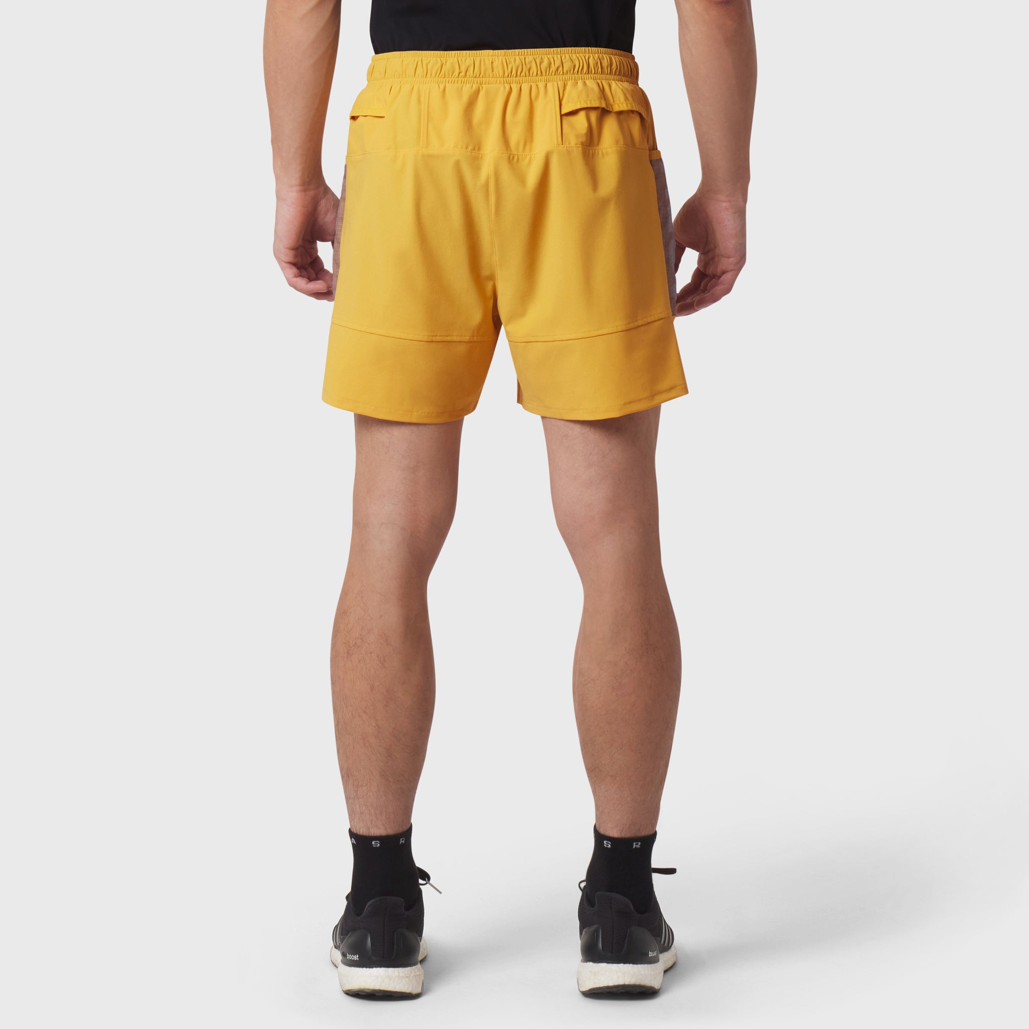 Tetra-Lite Adventure Short in amber yellow, back view on model