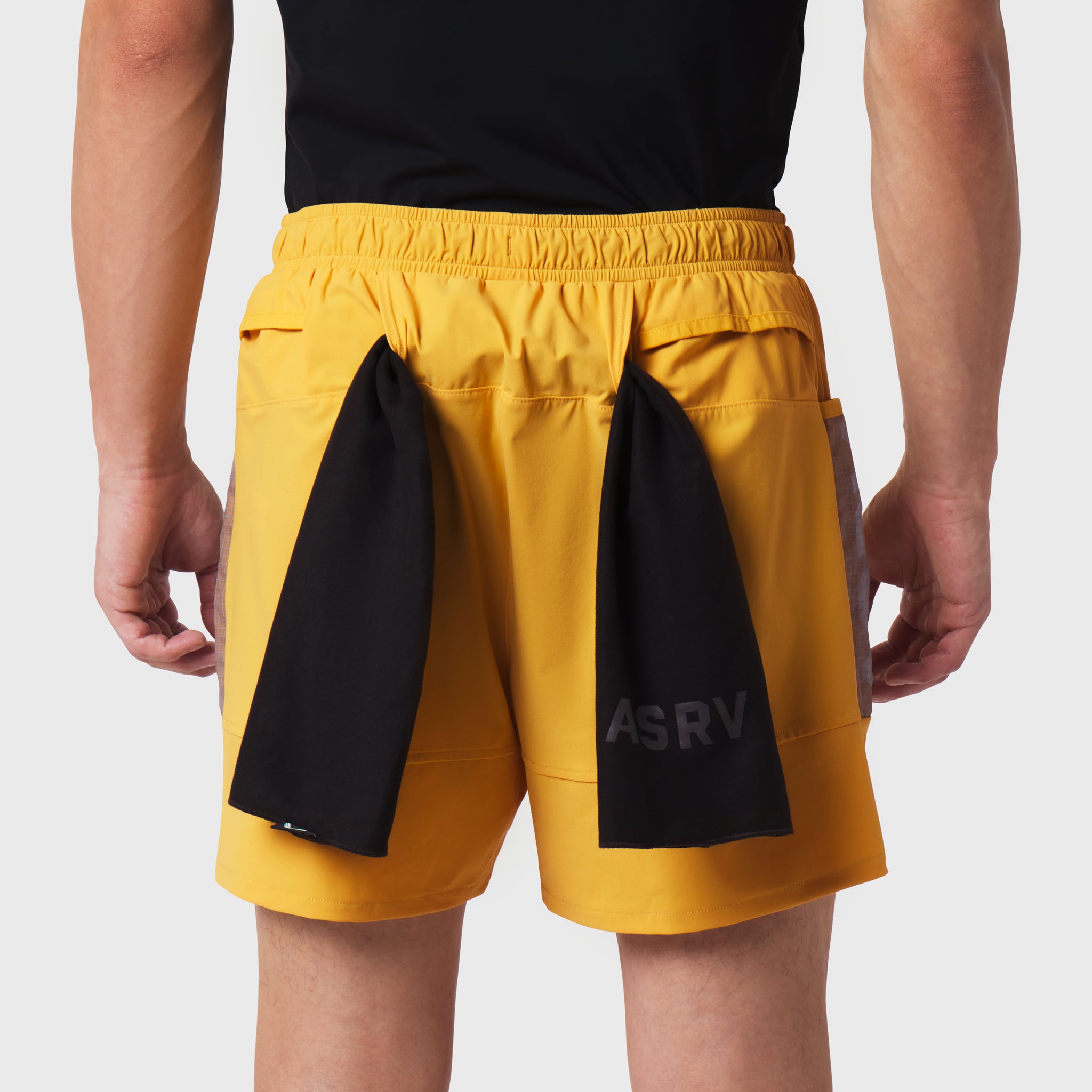 Tetra-Lite Adventure Short in amber yellow with black side panels, worn by model from behind