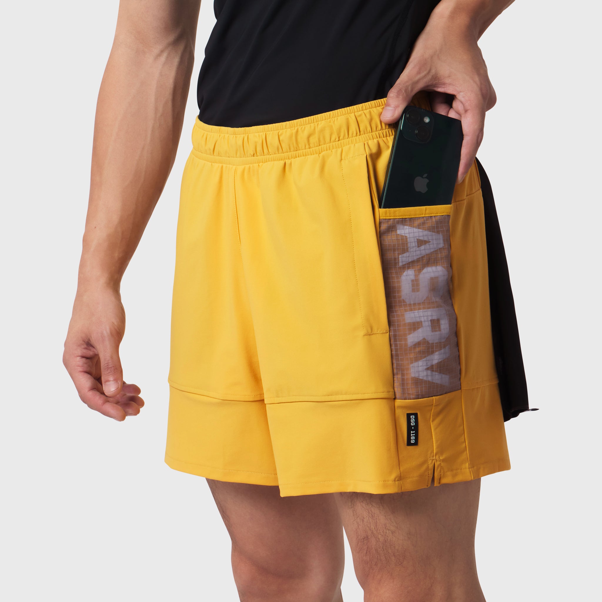 Tetra-Lite Adventure Short in amber yellow worn by model, side view showing phone pocket