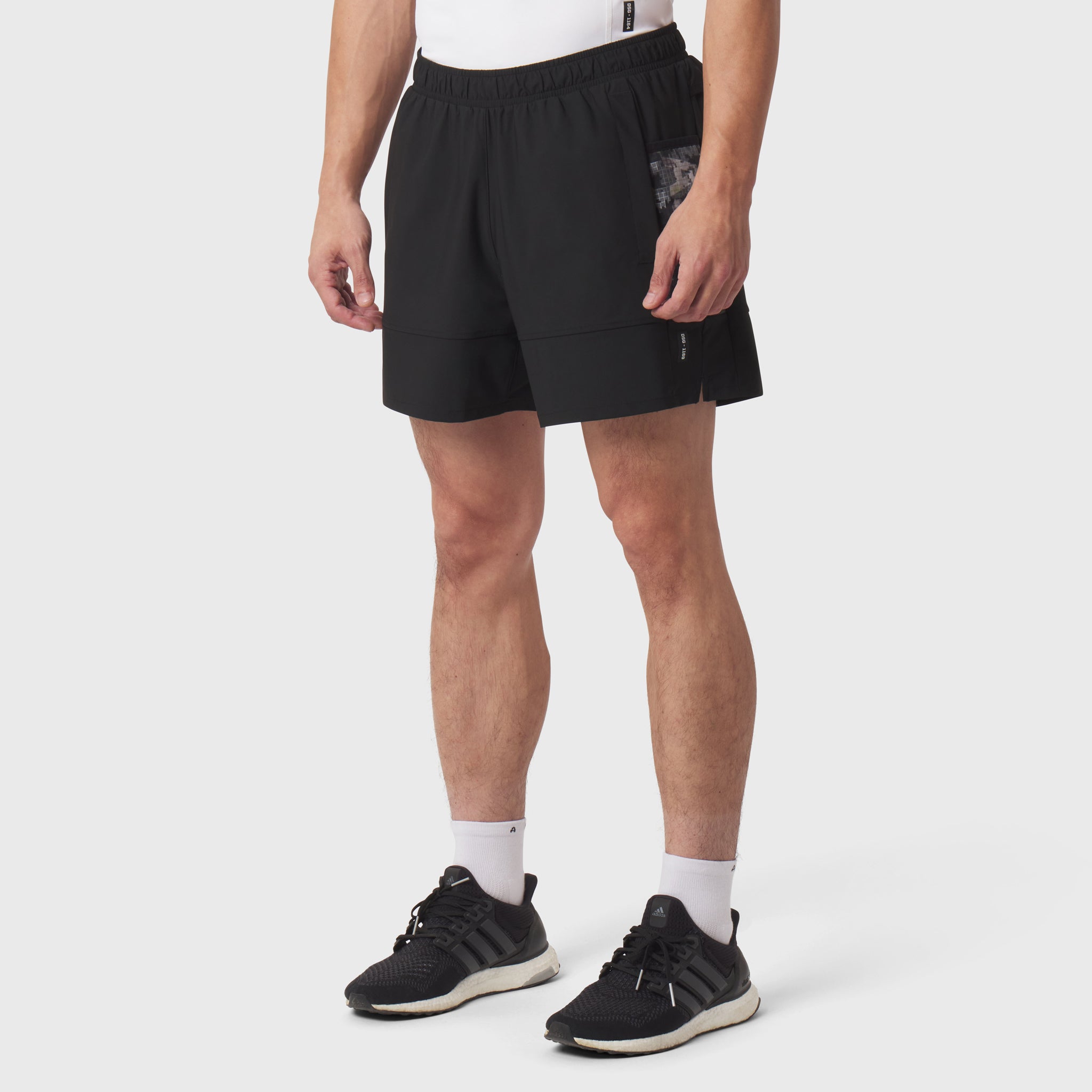 Tetra-Lite Adventure Short in black, worn by model with white socks and black sneakers