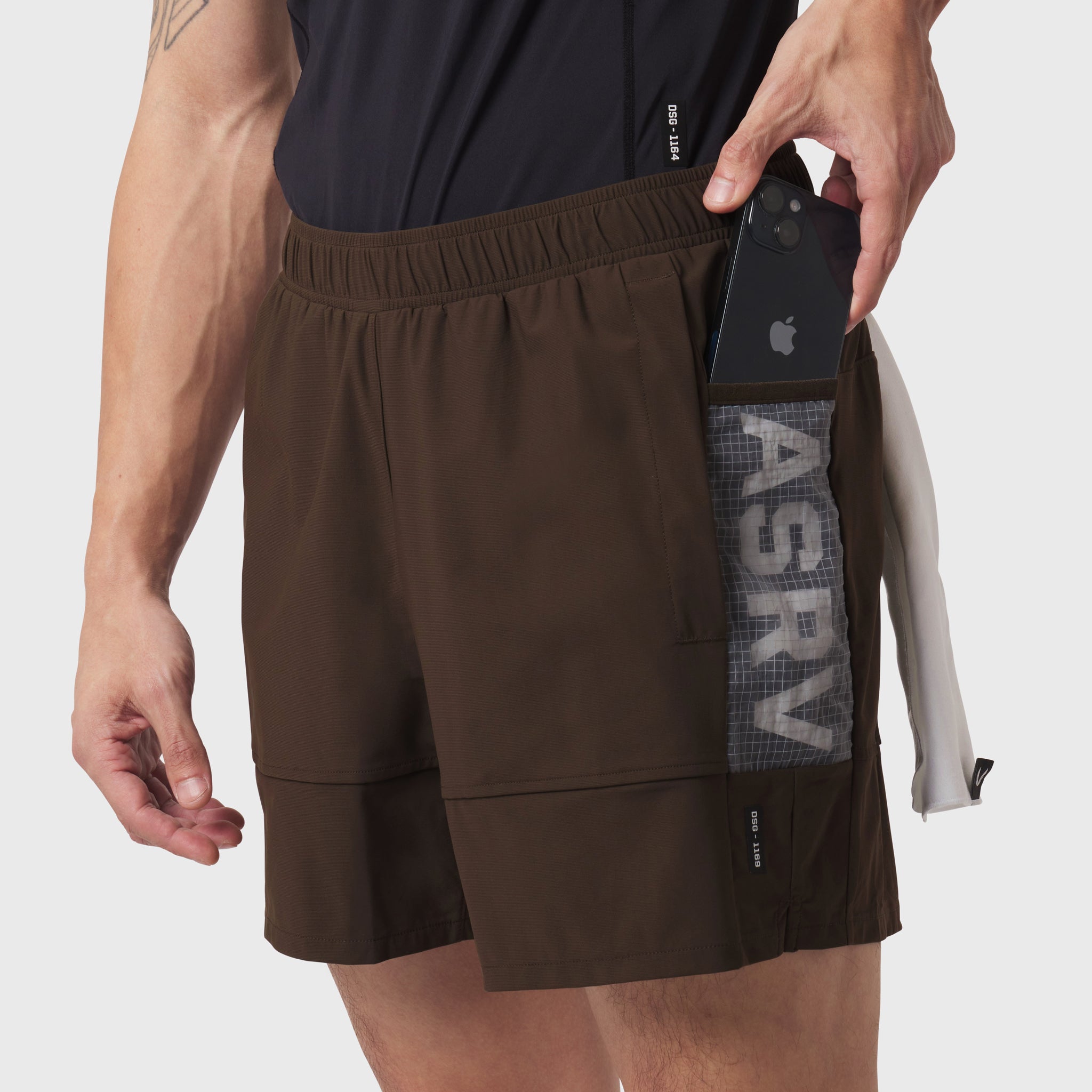 Tetra-Lite Adventure Short in dark earth worn by model, demonstrating side pocket with phone storage