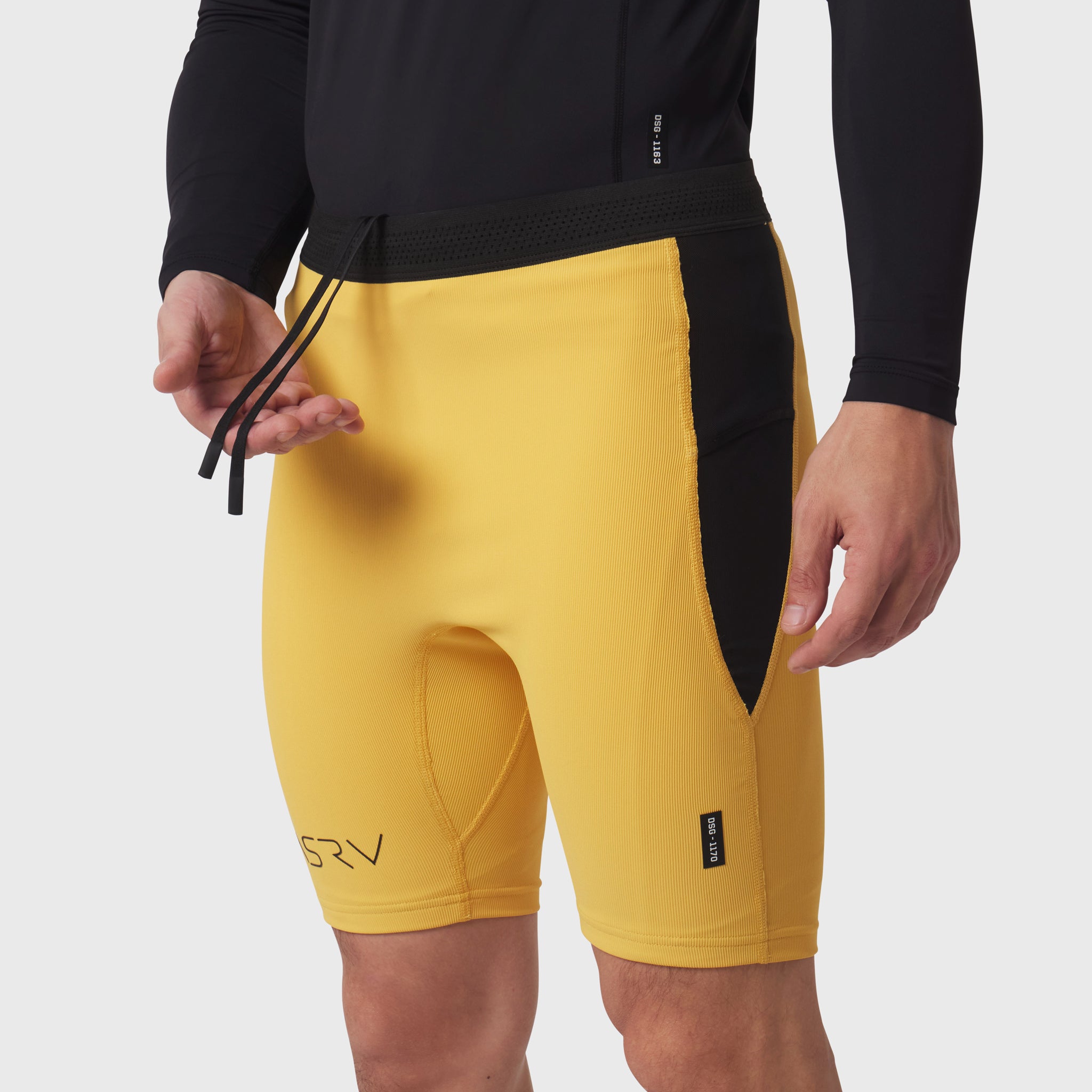 Lycra® Ribbed Run Half-Tight shorts in amber yellow, worn by model, front view