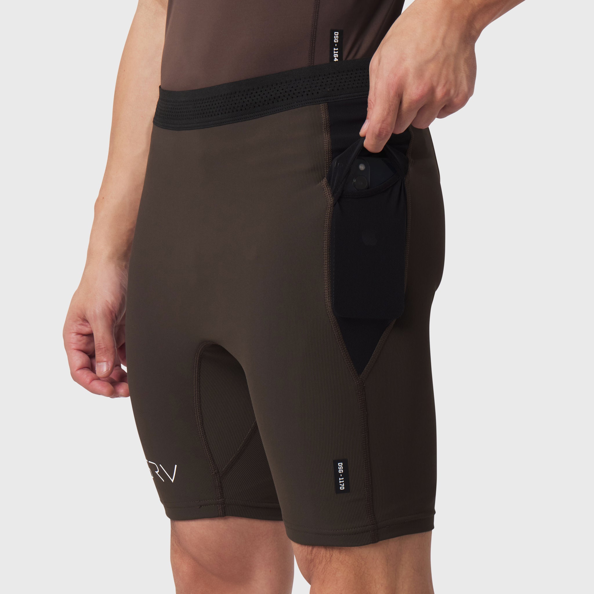 Dark earth Lycra ribbed run half-tight shorts on model, side view with pocket detail