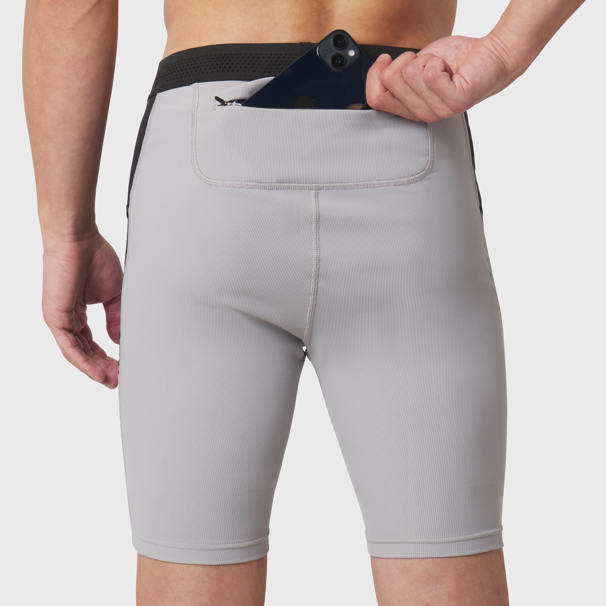 Lycra® Ribbed Run Half-Tight in slate grey worn by model, back view with phone in pocket