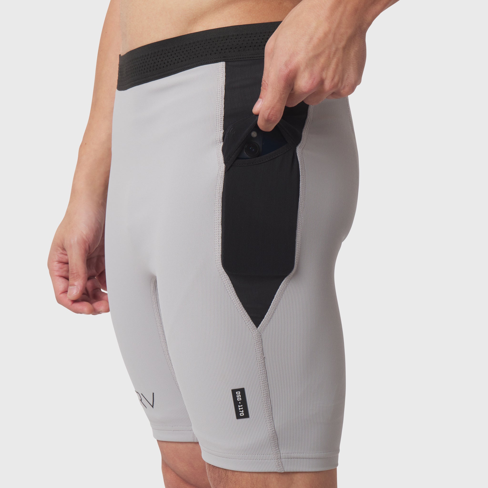 Lycra® Ribbed Run Half-Tight in slate grey, worn by model showing side view with hand at waistband