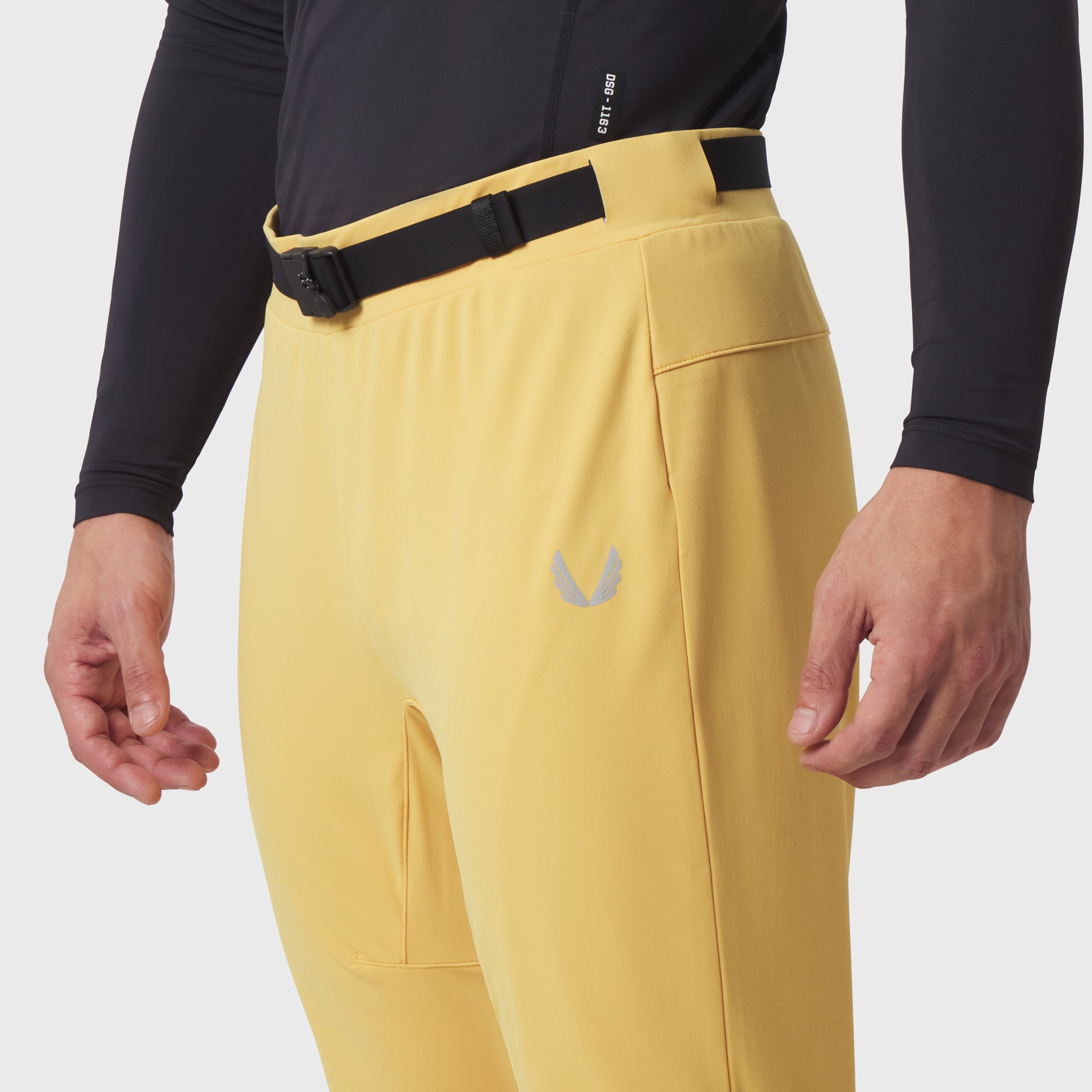Hybrid Belt-Pack Run Jogger in amber yellow worn by model, front waist detail