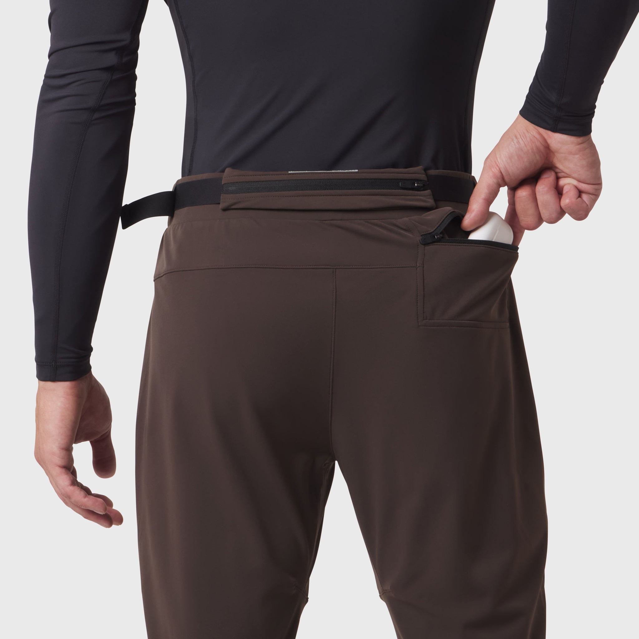 Hybrid Belt-Pack Run Jogger in dark earth, worn by model showing belt-pack detail at waist
