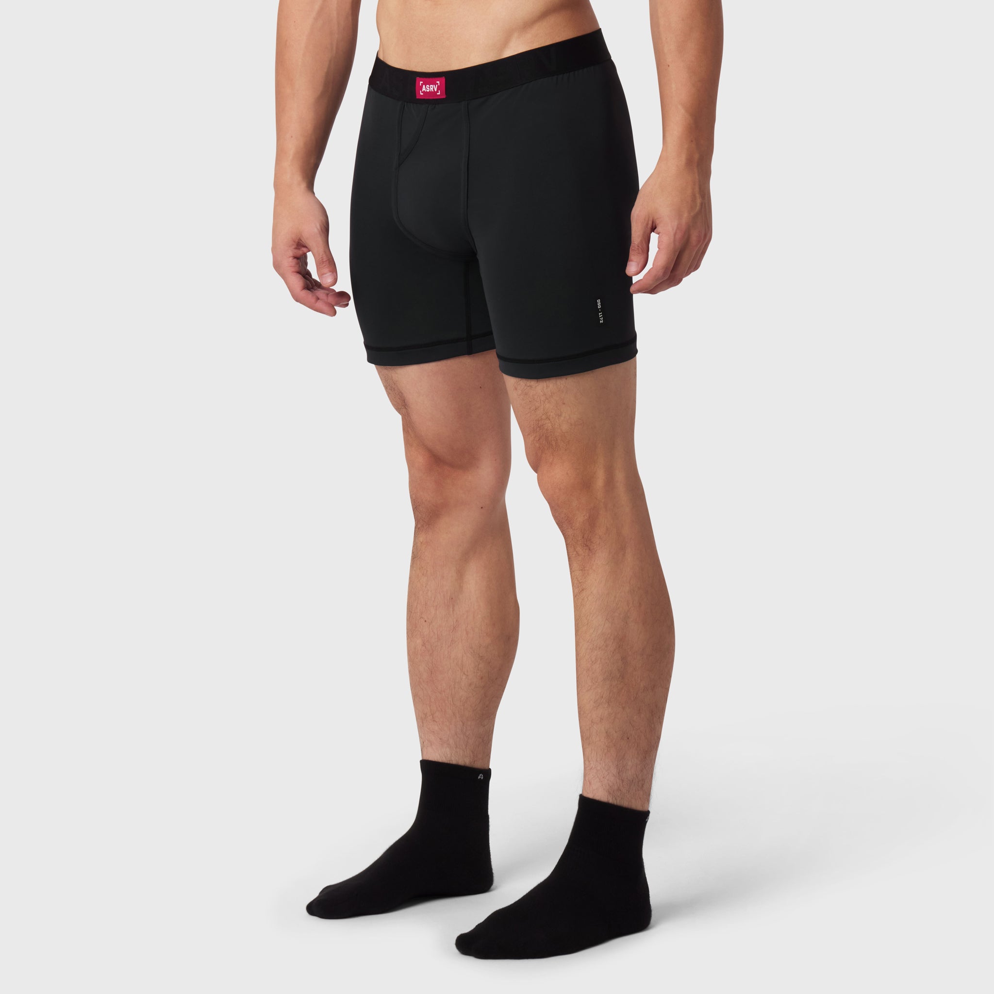 Black LYCRA® ADAPTIV briefs worn by male model with black socks, front view