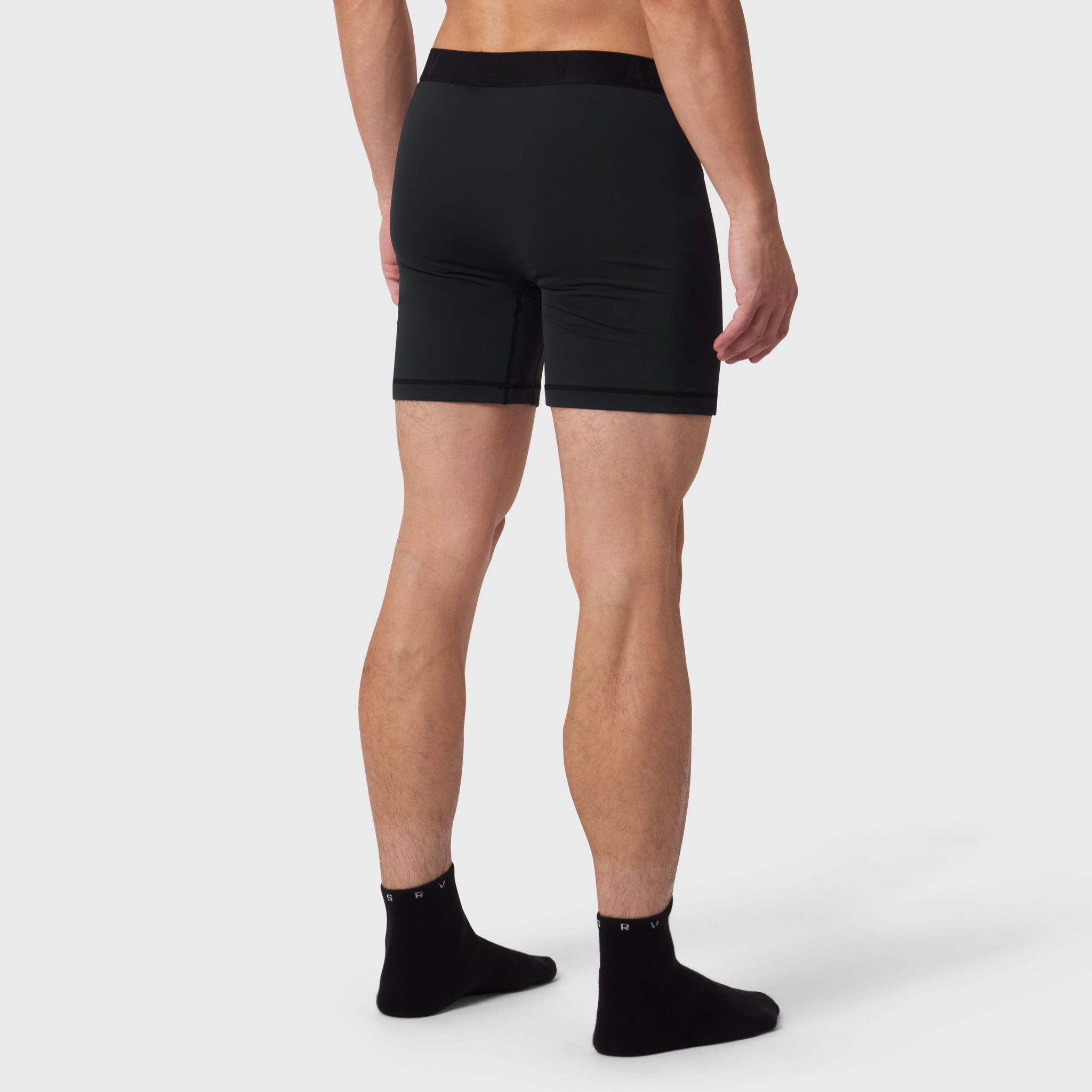 Black LYCRA® ADAPTIV briefs worn by model, rear view