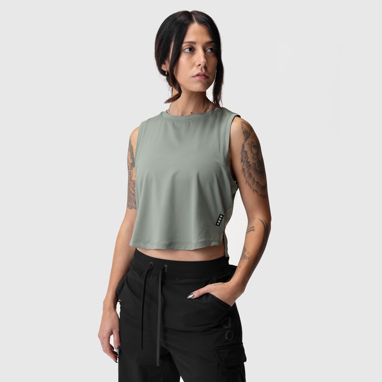 Sage green cropped training tank on model, front view