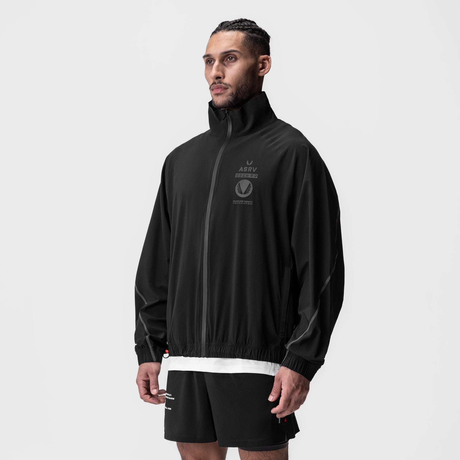Aerotex Track Jacket in black with white stripe, worn by model in three-quarter view