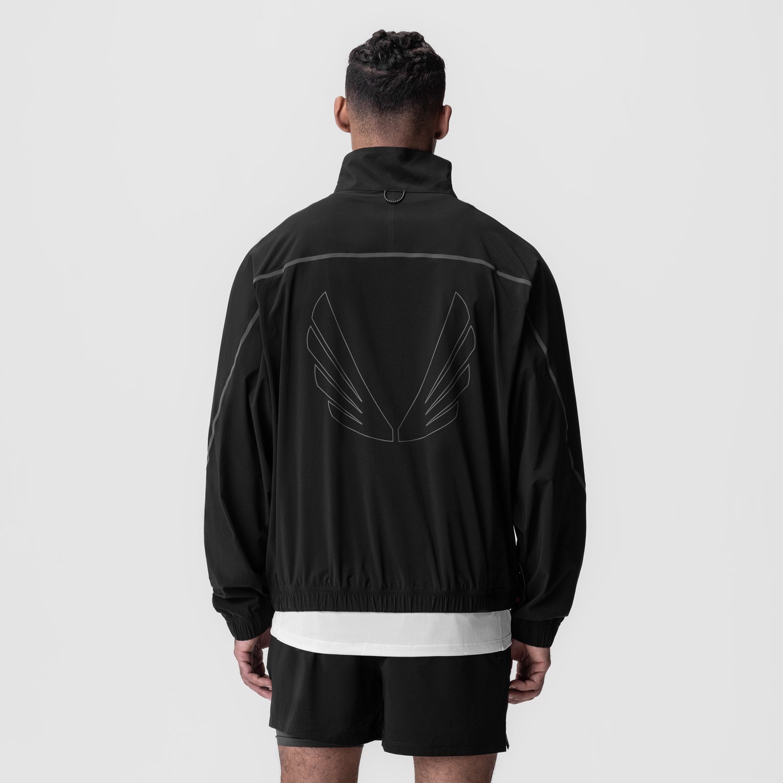 Aerotex™ Track Jacket in black with winged back graphic, worn by model from behind