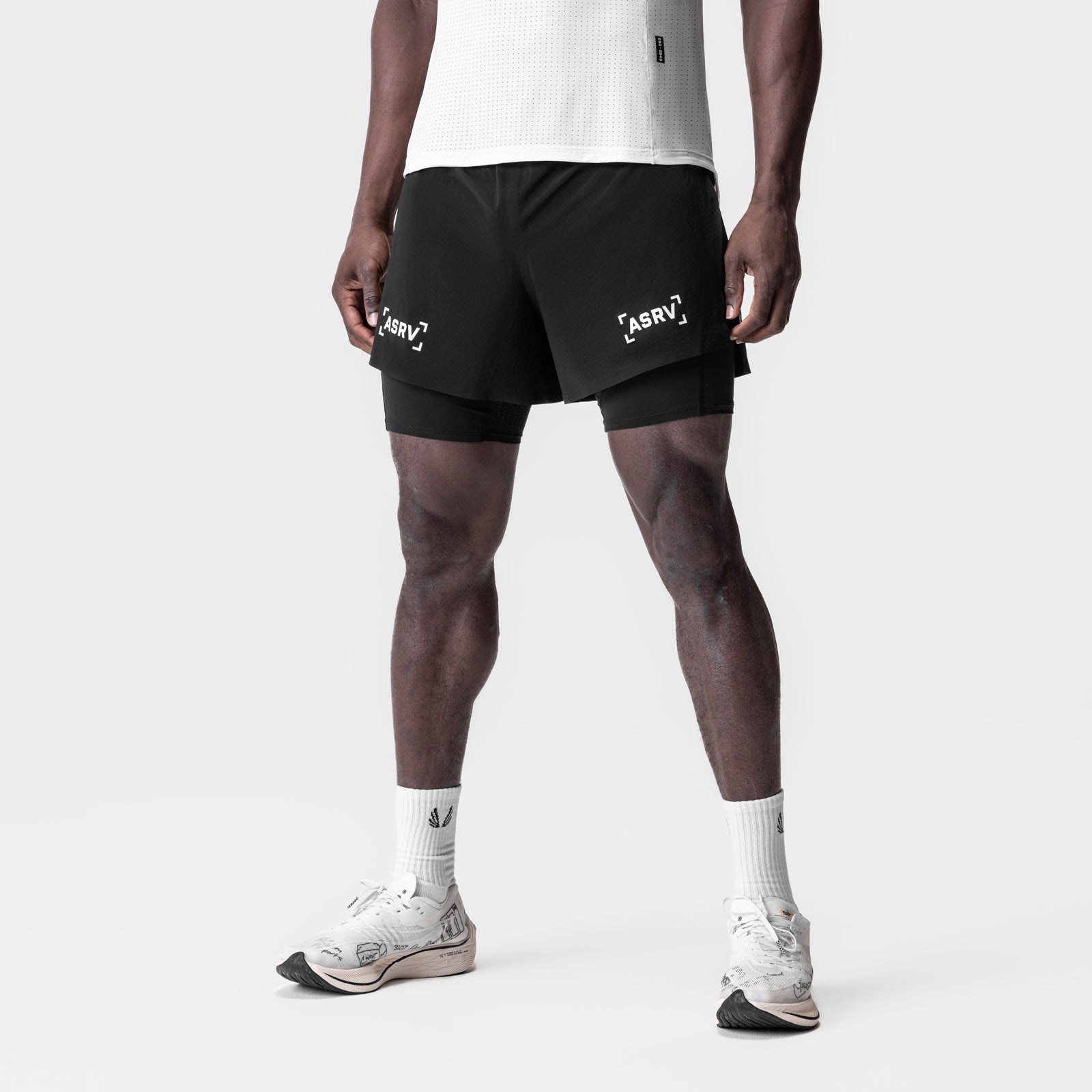 Aerotex 4" High Split Liner Shorts in black with white liner, worn by male model, front view
