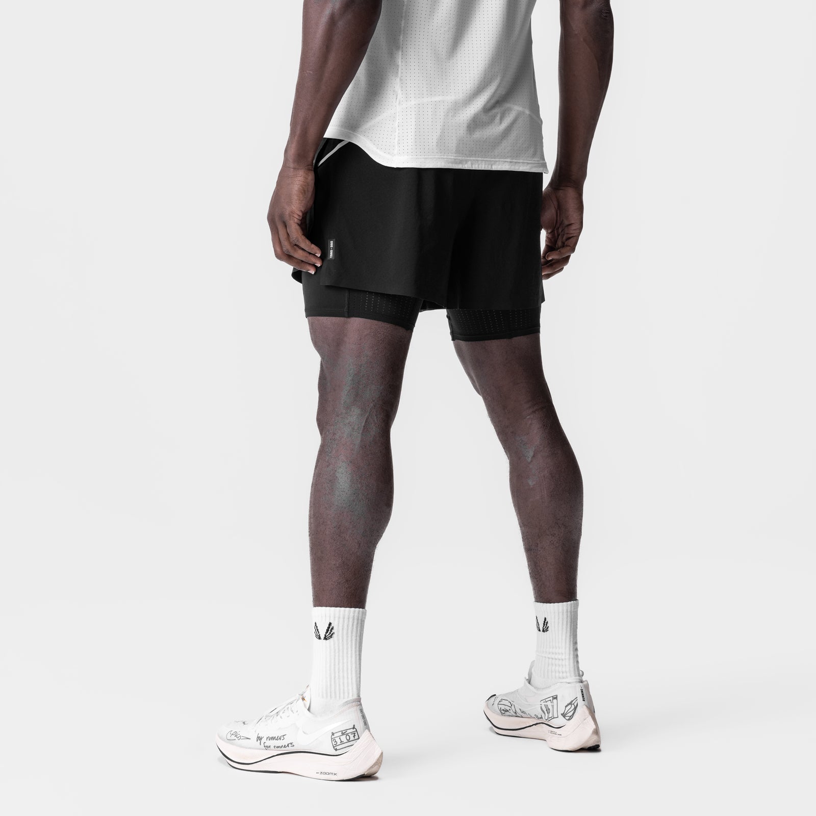Aerotex 4" High Split Liner Short in black with white liner, worn by model, back view