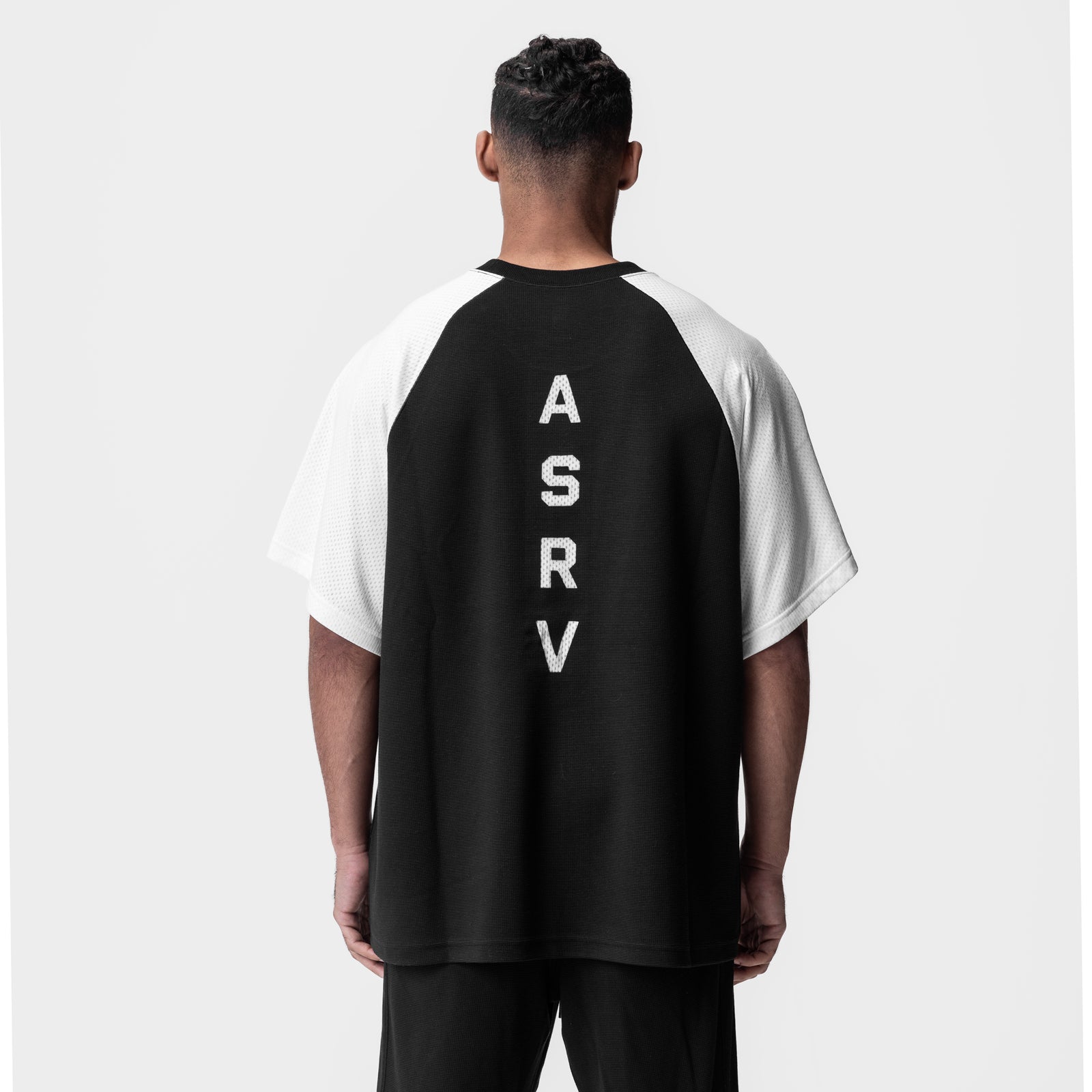 Waffle knit oversized tee in black and white, back view on model