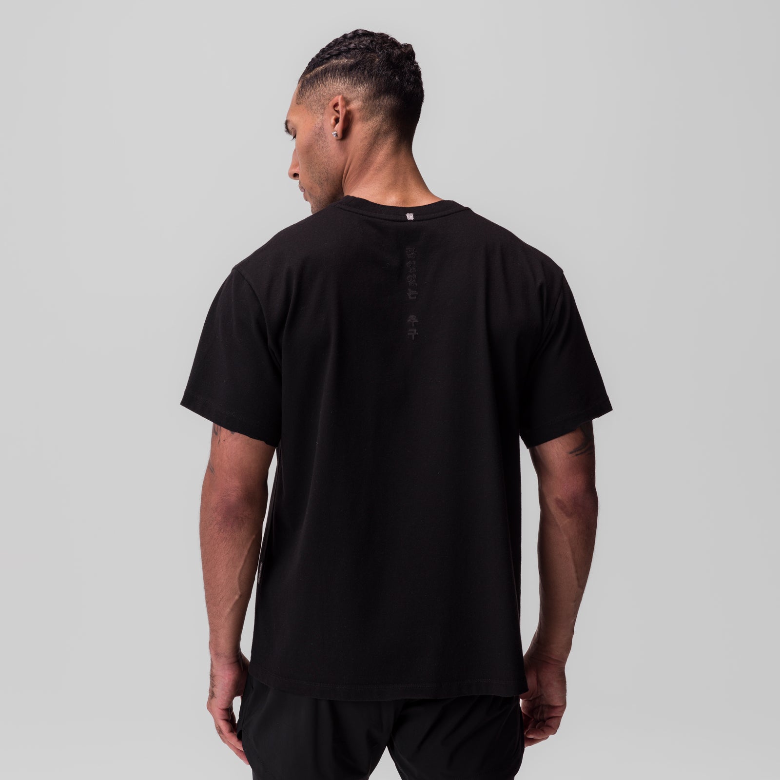 Black Tech Essential Relaxed Tee worn by model, back view