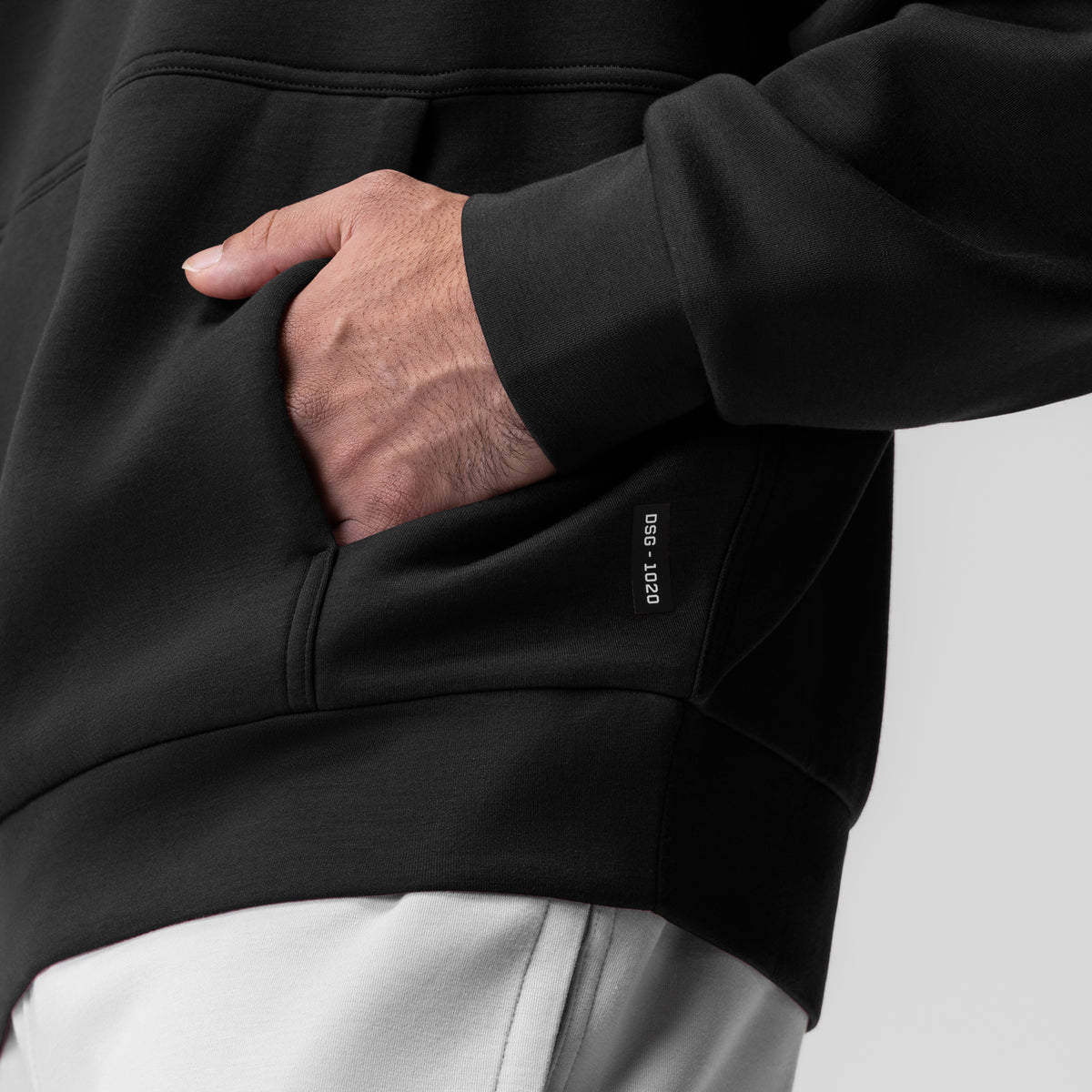 Dri-Core Oversized Crewneck in black, model wearing with hand in kangaroo pocket