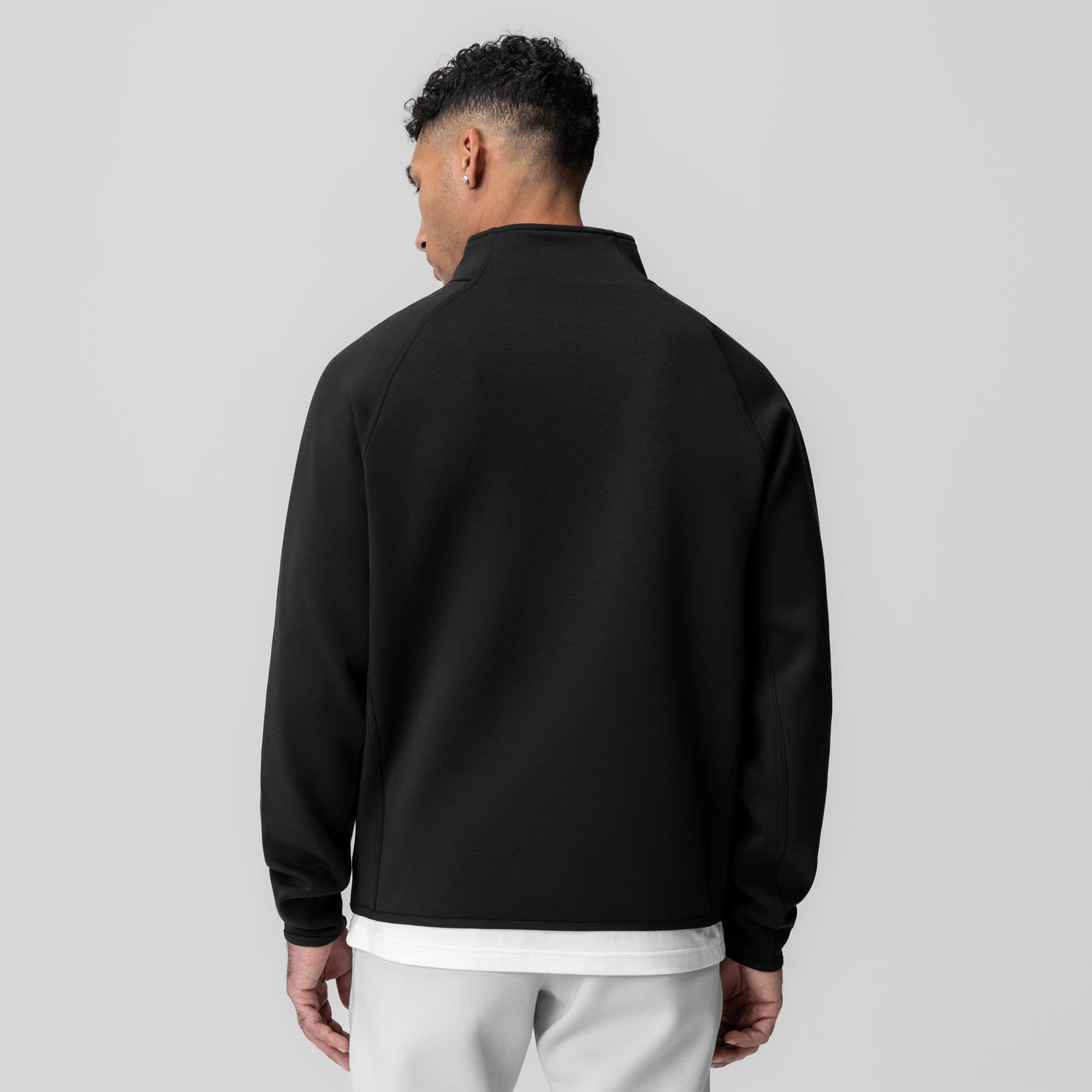 Dri-Core Quarter Zip in black, worn by model shown from back