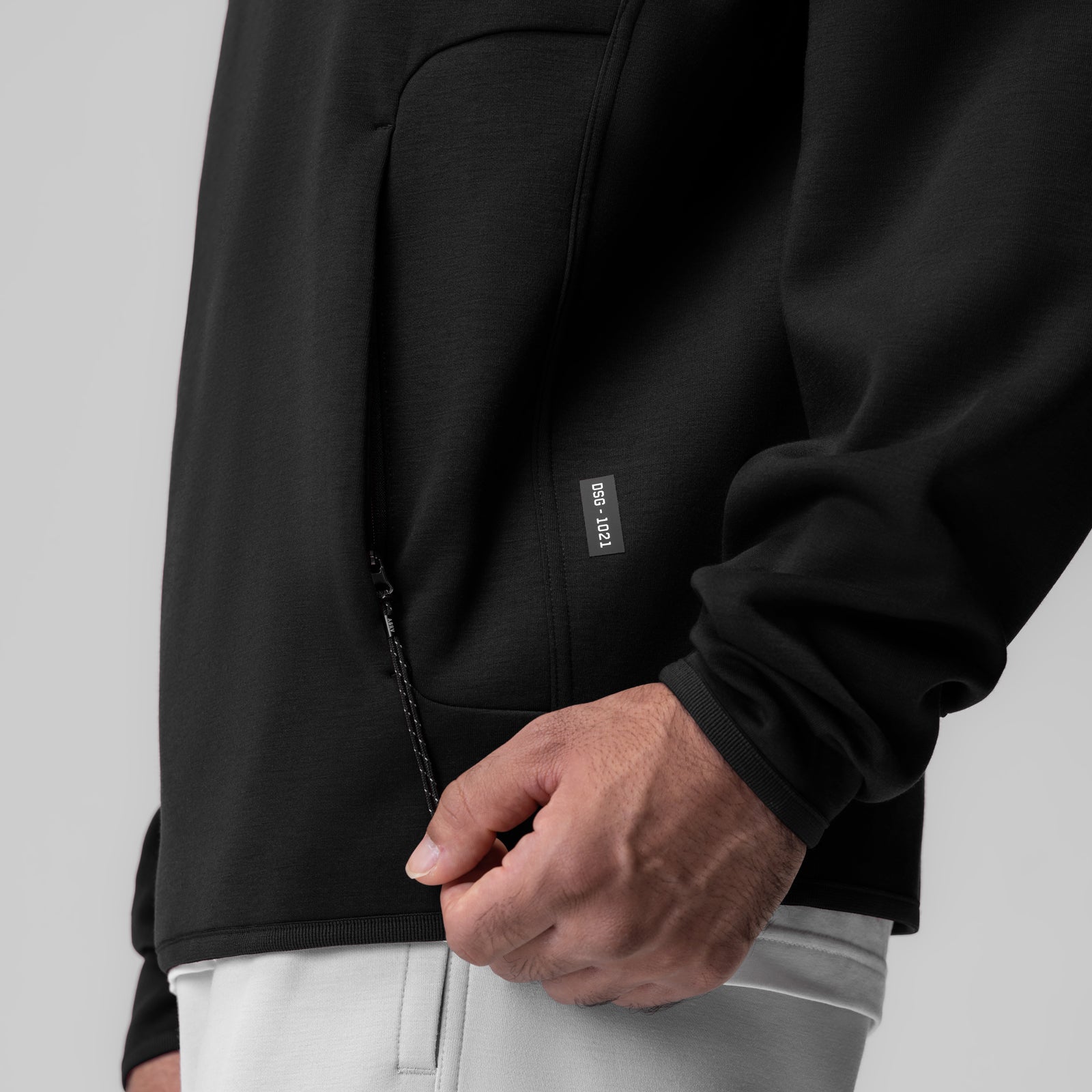 Dri-Core Quarter Zip in black worn by model, side detail view showing pocket and zipper