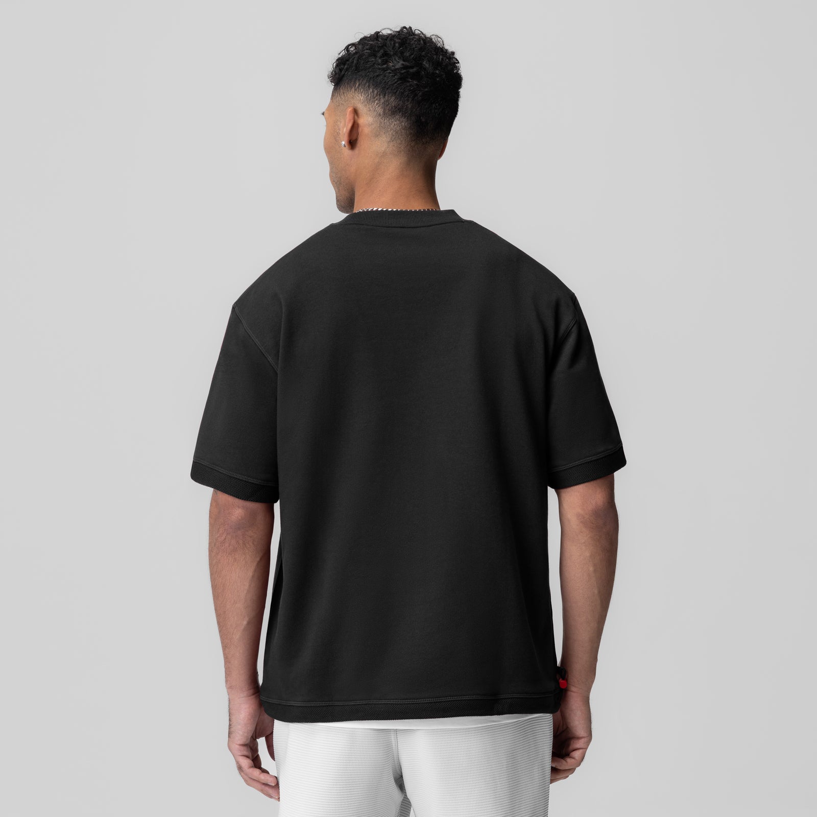 Herringbone Terry Oversized Cinch Tee in black, worn by model shown from back