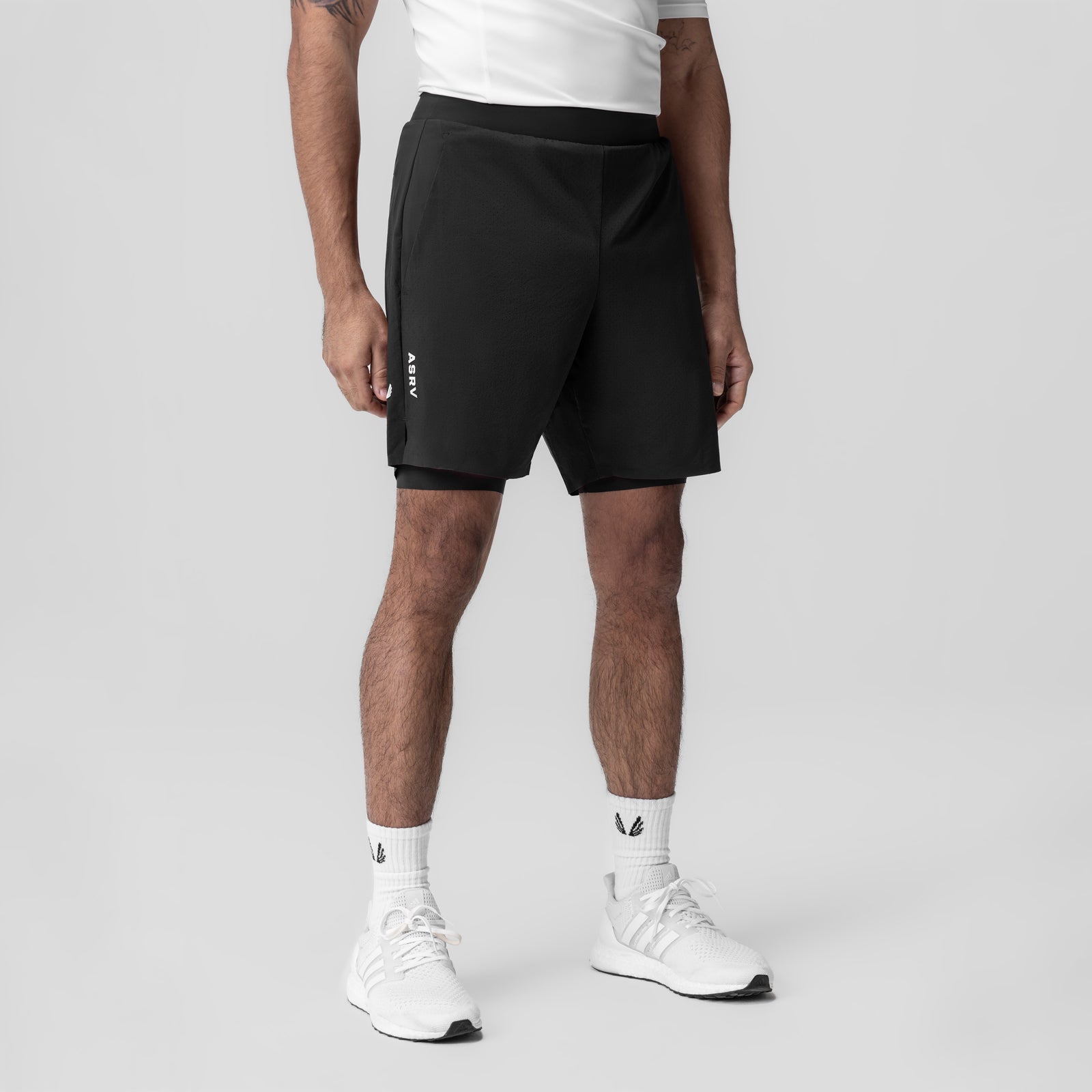 Aerotex Bonded 7" Liner Short in black, modeled front view with white sneakers