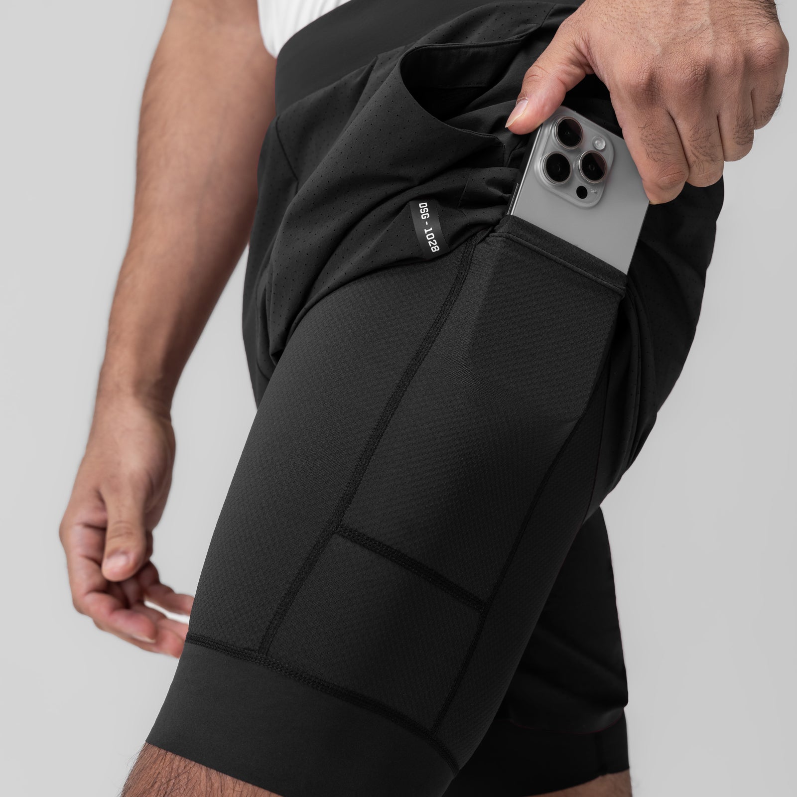 Black Aerotex Bonded 7" Liner Short worn by model, side view with phone in pocket