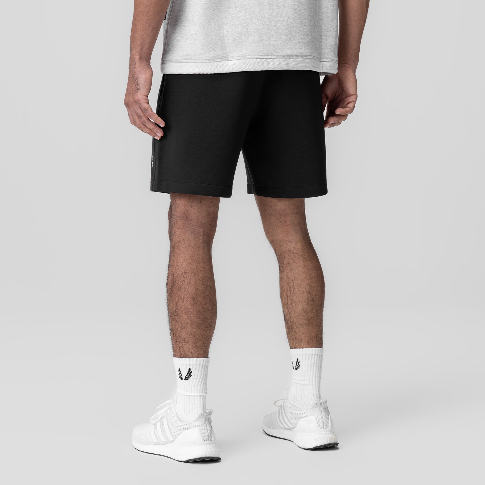 Dri-Core Training Short in black, worn by model from waist down with white socks and sneakers