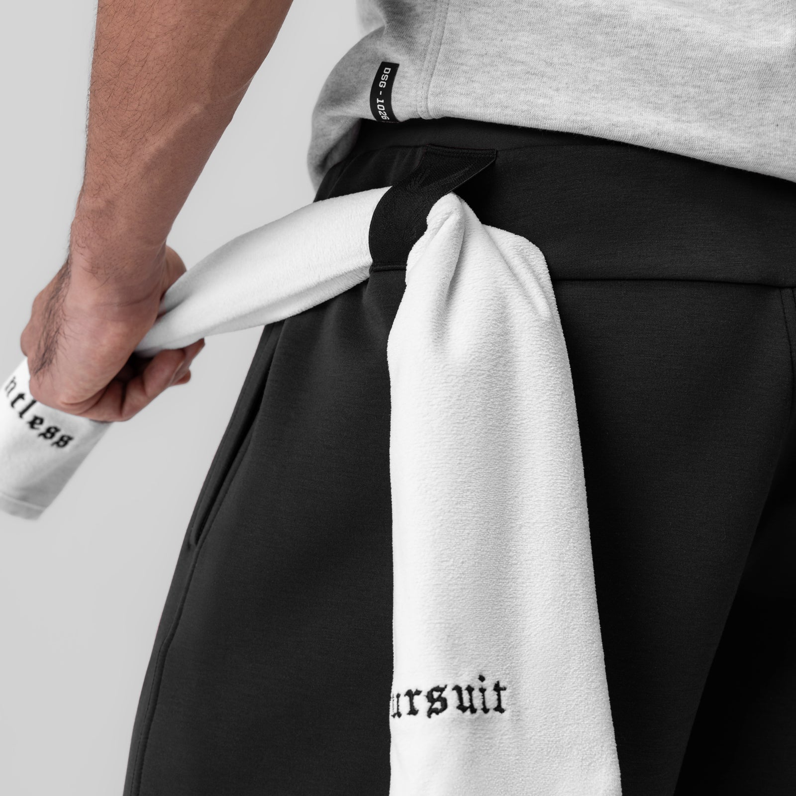 Dri-Core™ Training Short in black being held by model, showing towel detail