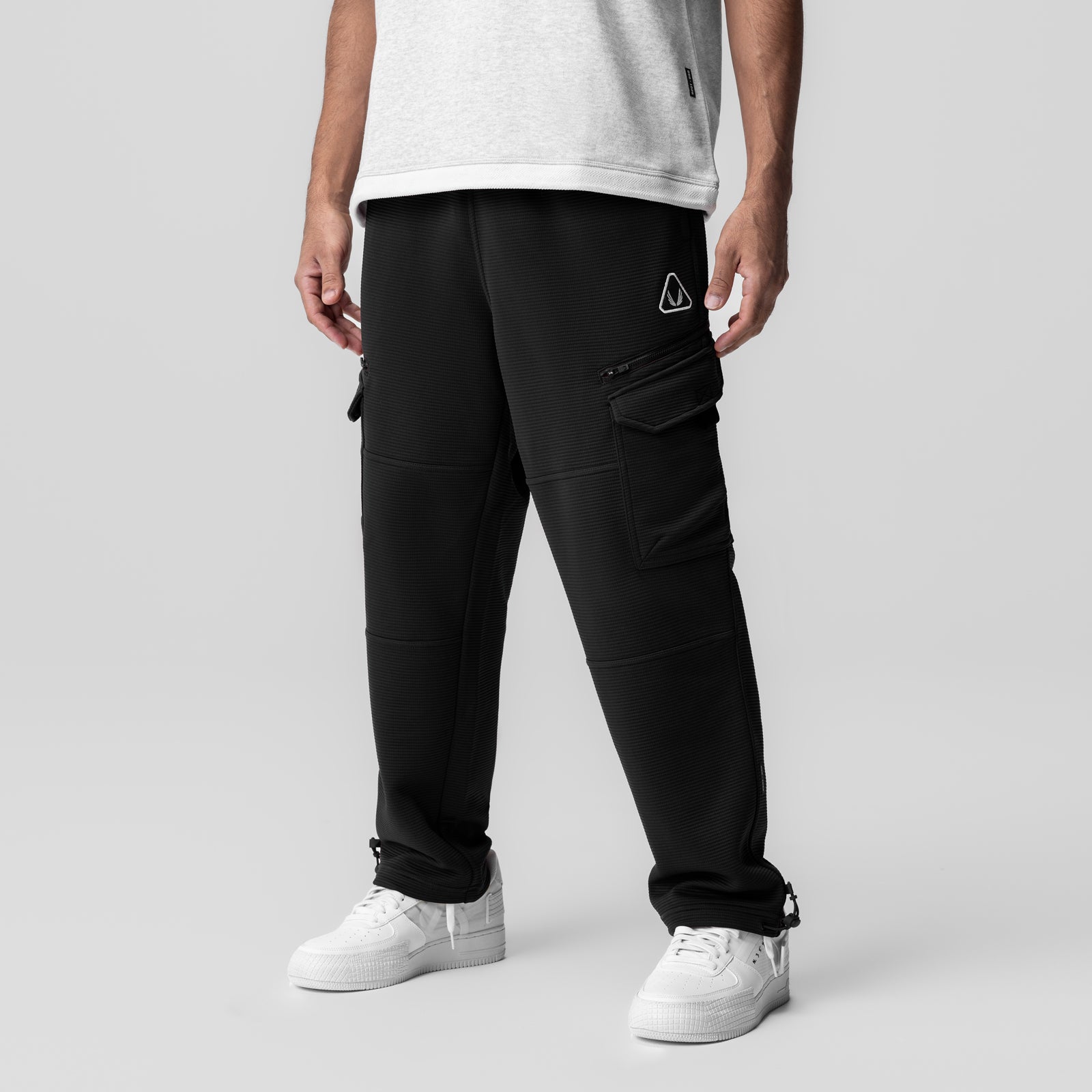 Black Deltapeak Cargo Cinch Jogger worn by model with white sneakers, front view