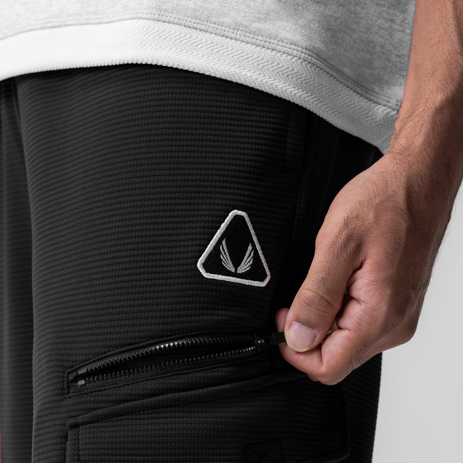 Black Deltapeak Cargo Cinch Jogger worn by model, detail shot of side pocket and zipper