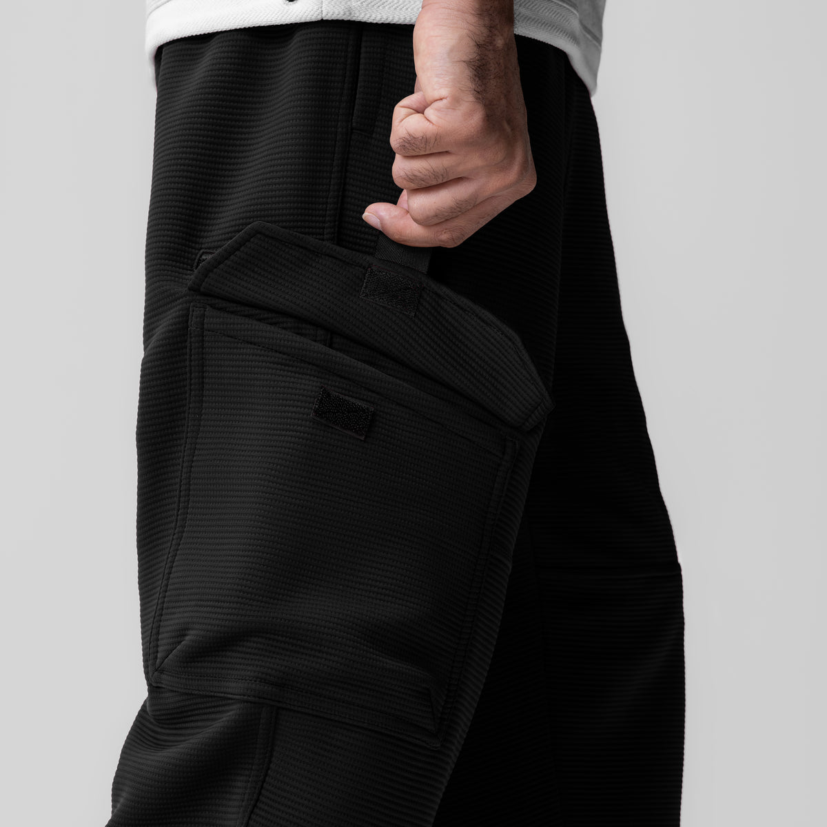 Deltapeak® Cargo Cinch Jogger in black, worn with hand in pocket detail