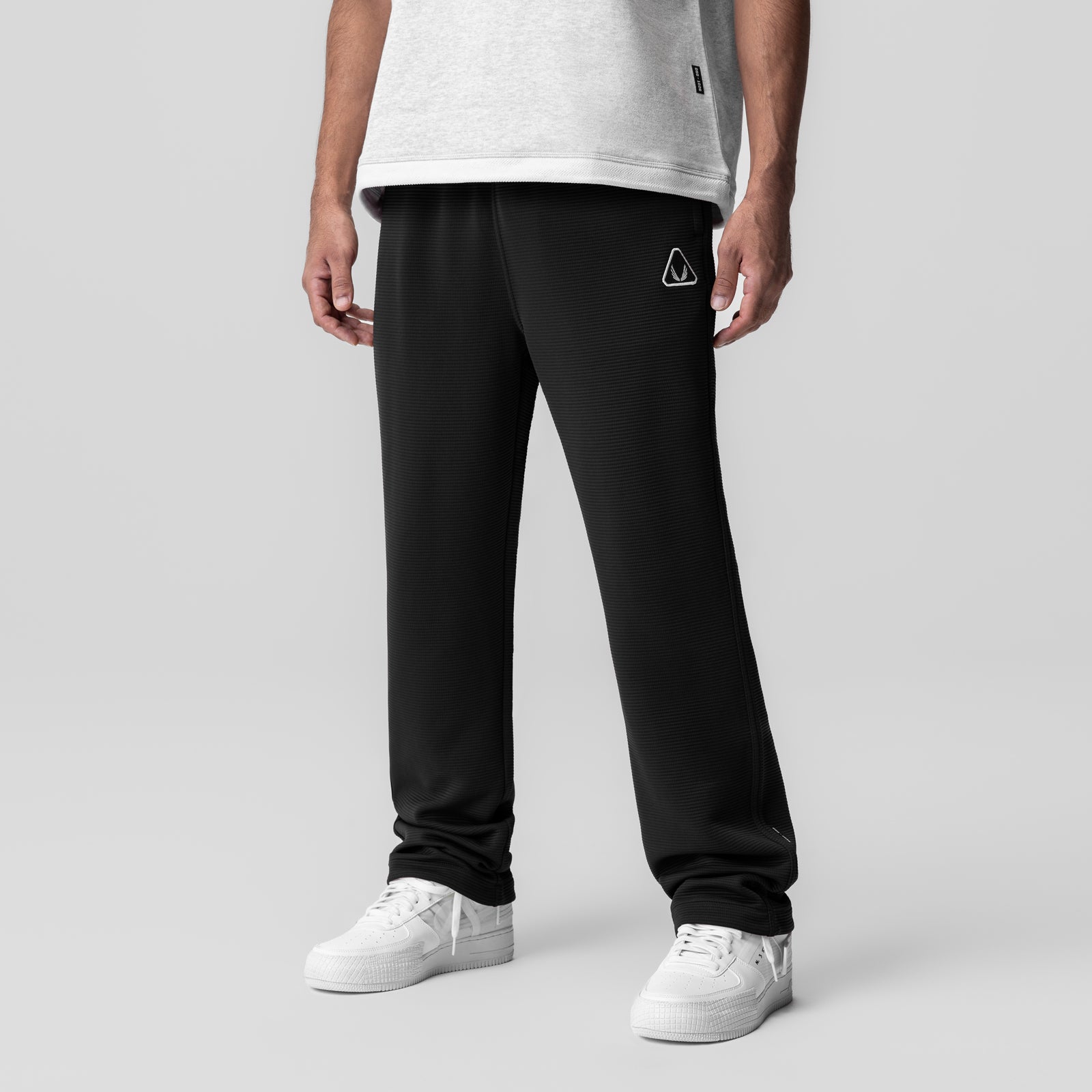 Deltapeak® Straight Leg Sweats in black worn by model with white t-shirt and white sneakers, front view