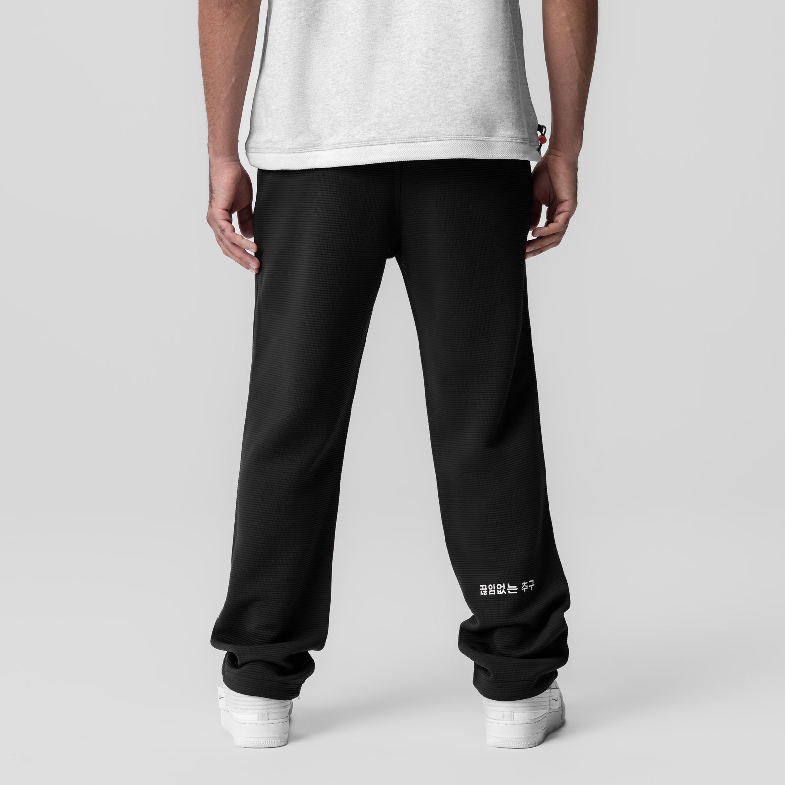 Deltapeak® Straight Leg Sweats in black, rear view on model wearing white sneakers