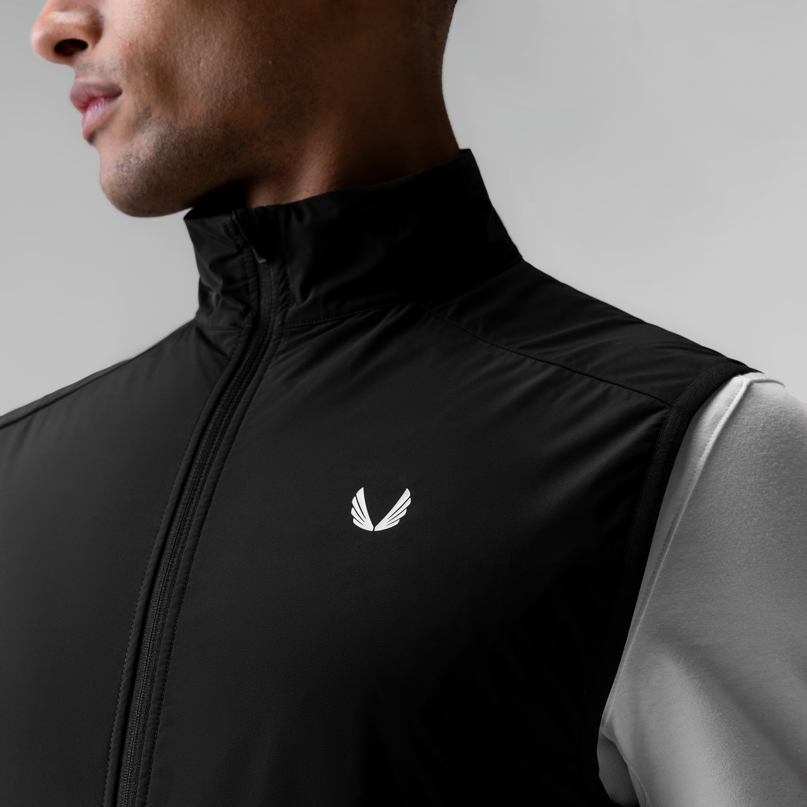 Aerotex PrimaLoft Run Vest in black, worn by model in side profile view