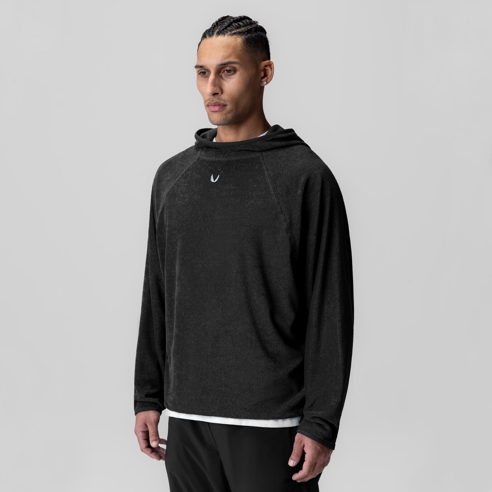 Black towel terry reversible hoodie worn by model, front view