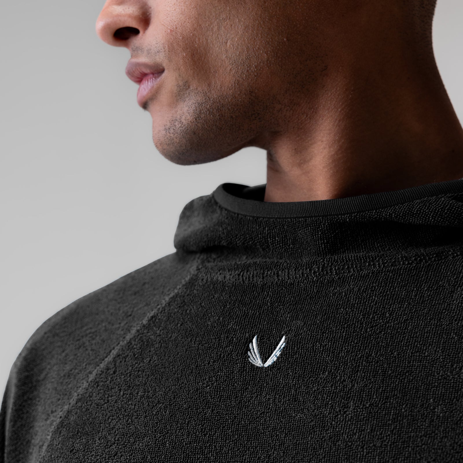 Black Towel Terry Reversible Hoodie worn by model in profile view